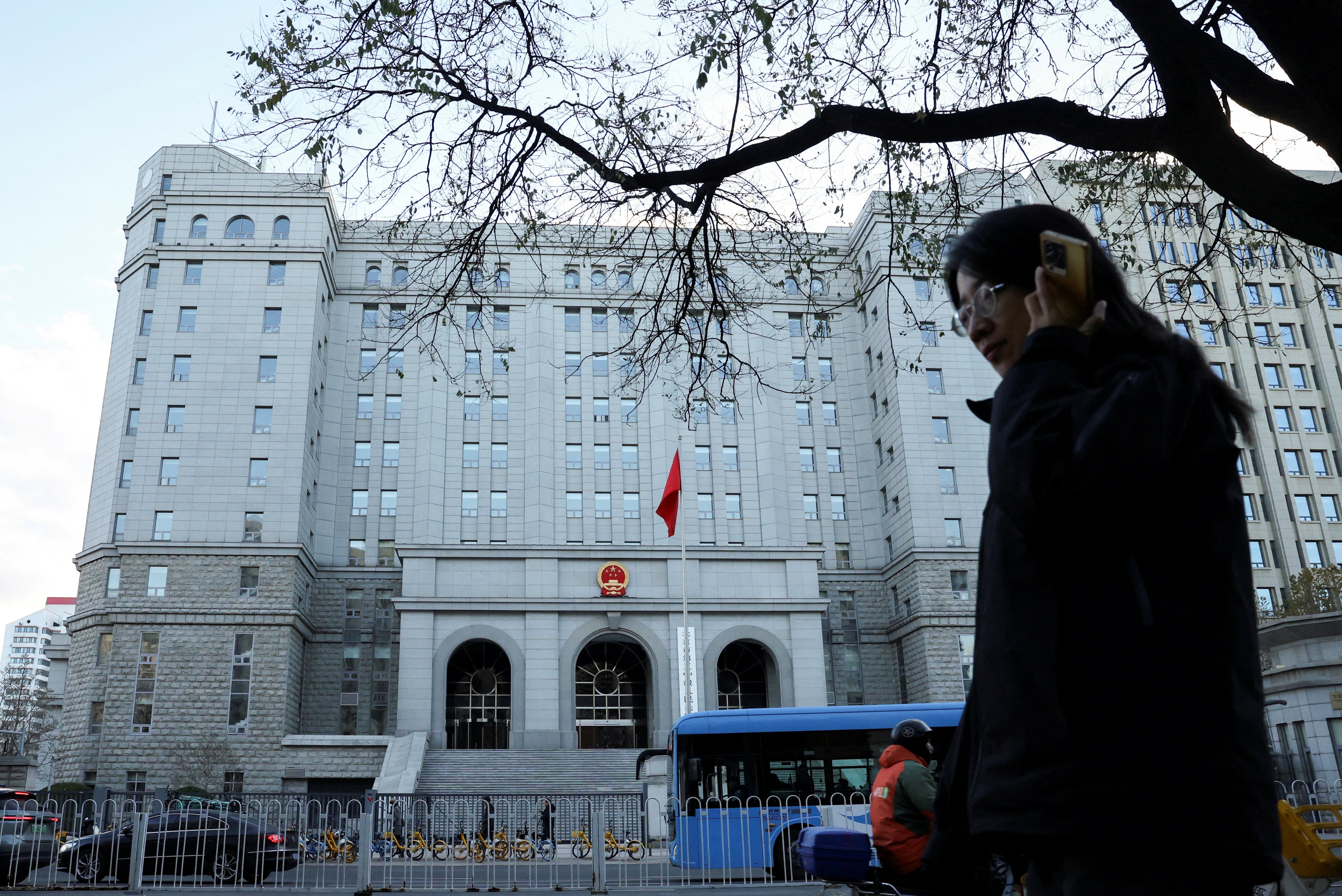 A pedestrian walks past the Beijing court where former journalist Dong Yuyu received his sentence