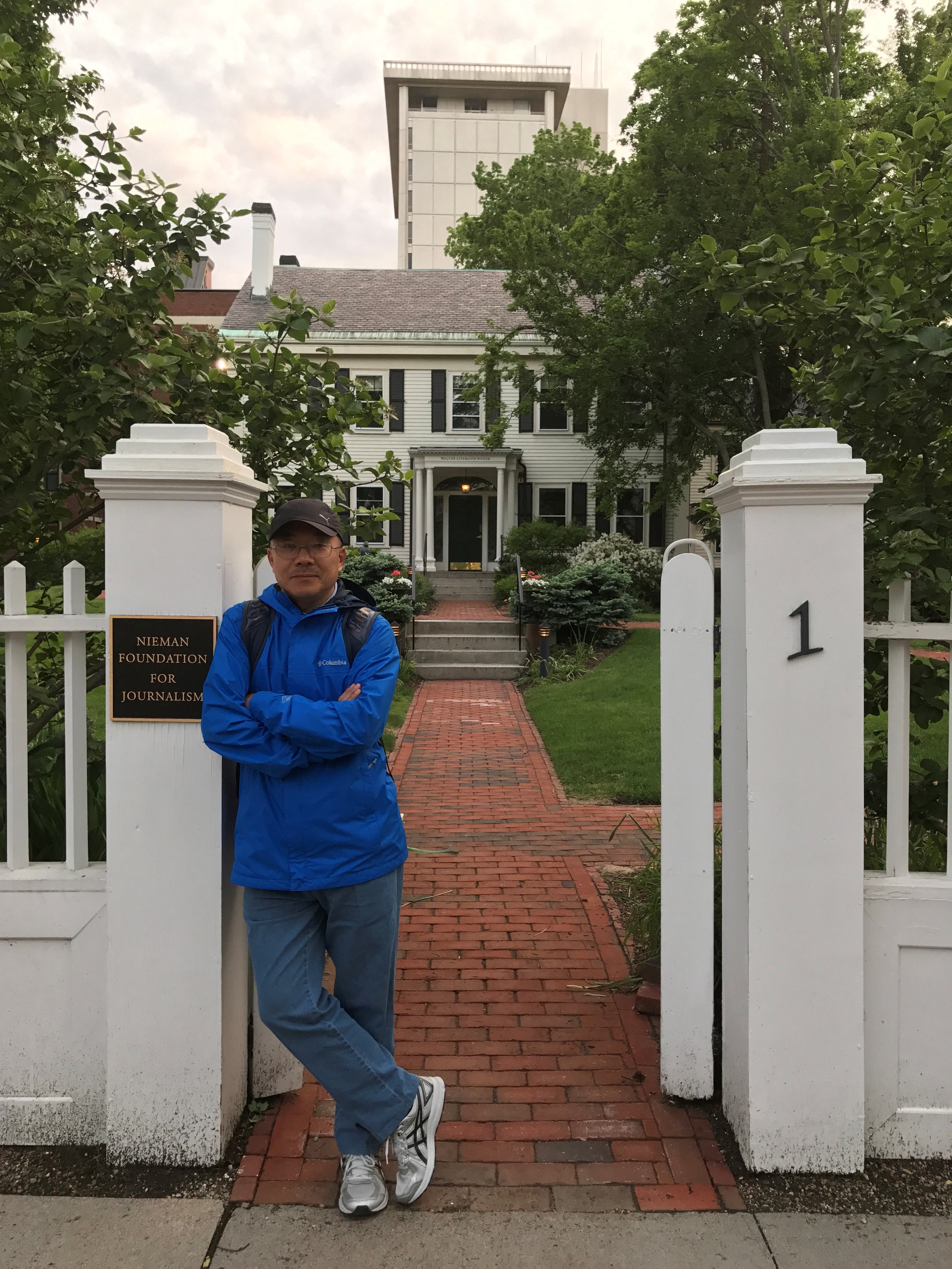 Dong Yuyu stands at the gate of the Nieman Foundation in Cambridge, Massachusetts, in 2017