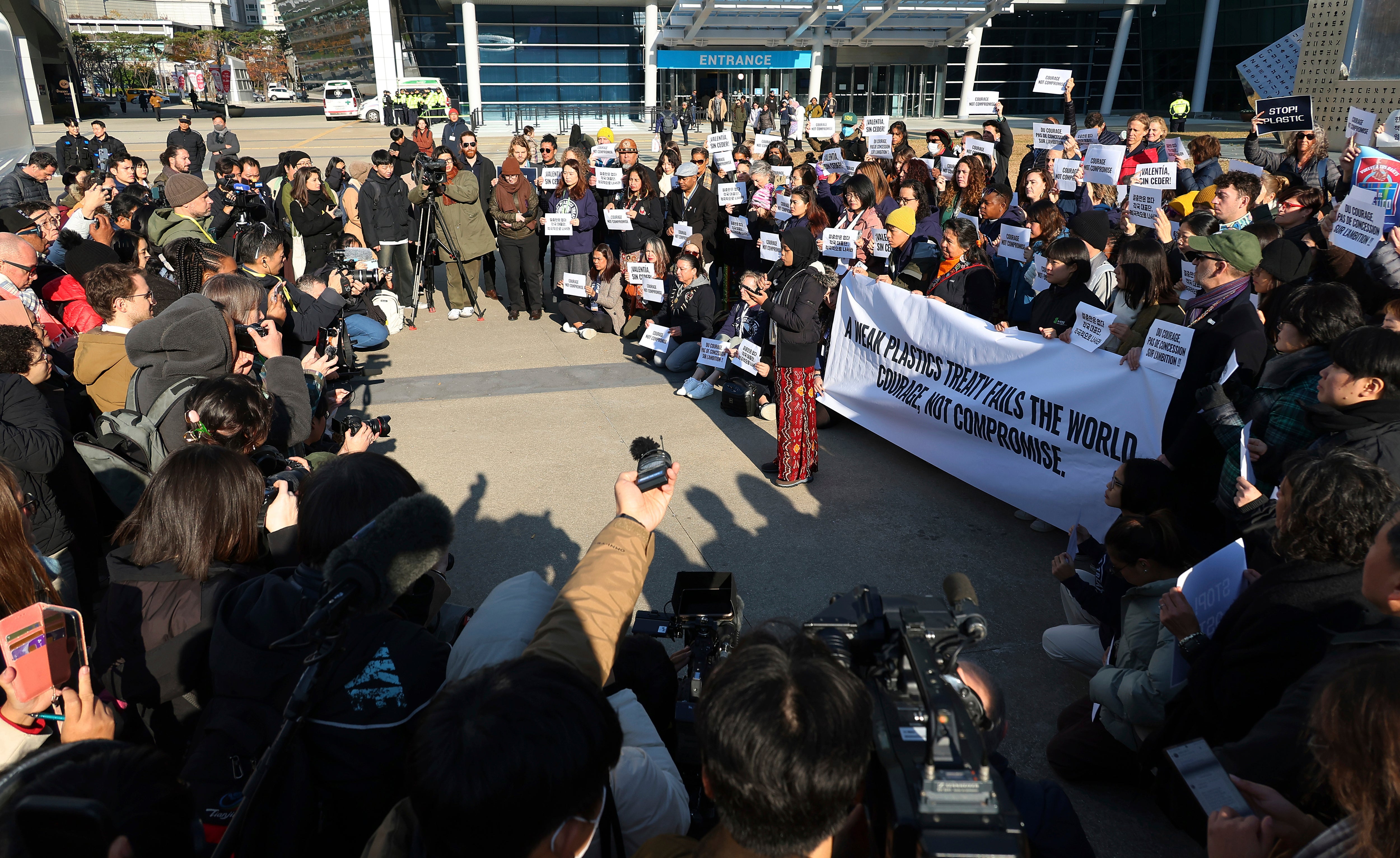 Environment activists hold a press conference calling for a strong global plastics treaty outside of the venue for the fifth session of the Intergovernmental Negotiating Committee on Plastic Pollution in Busan, South Korea