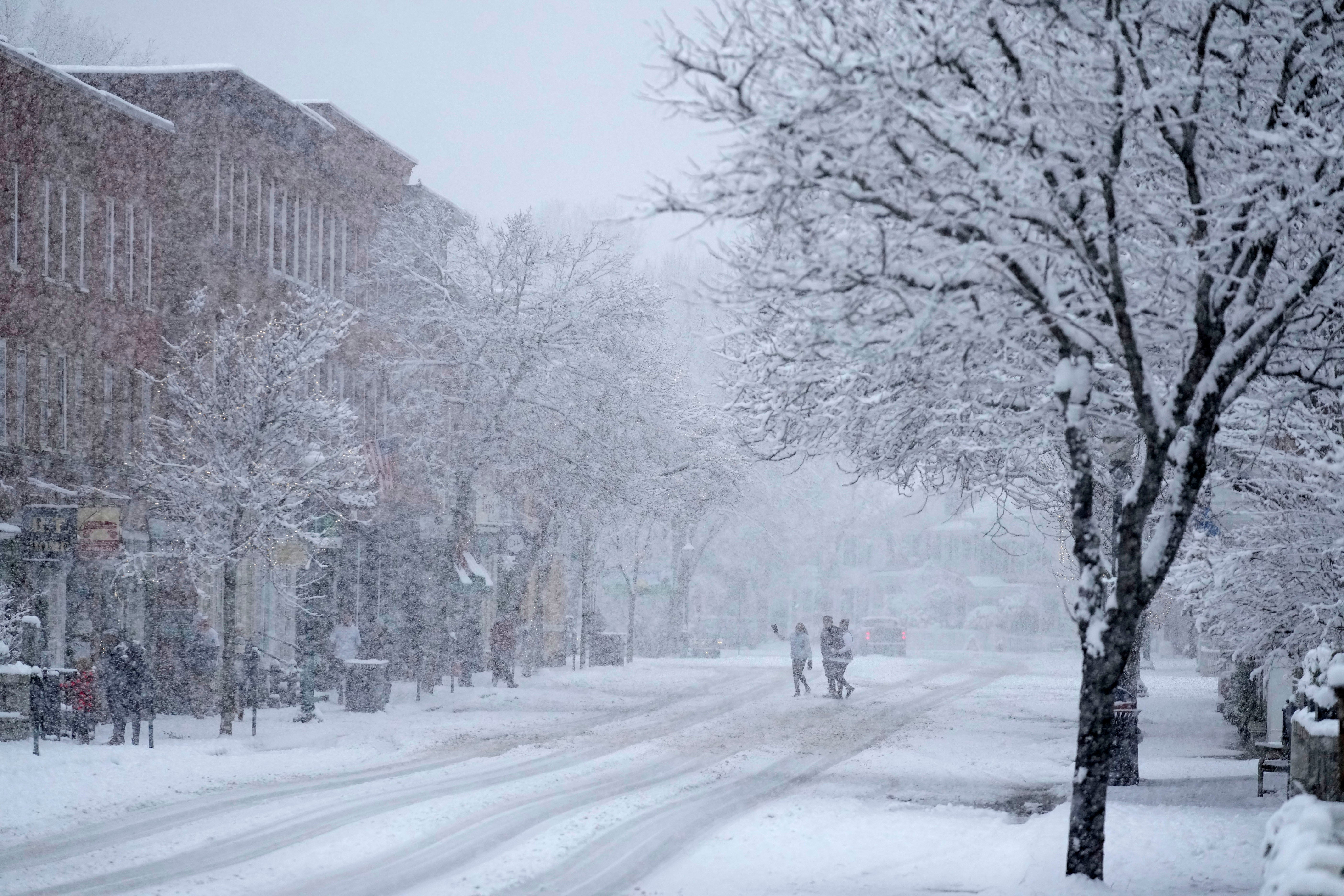 Holiday visitors walk in downtown Woodstock, Vermont, on Thanksgiving Day. More snow is forecast across the US through the weekend