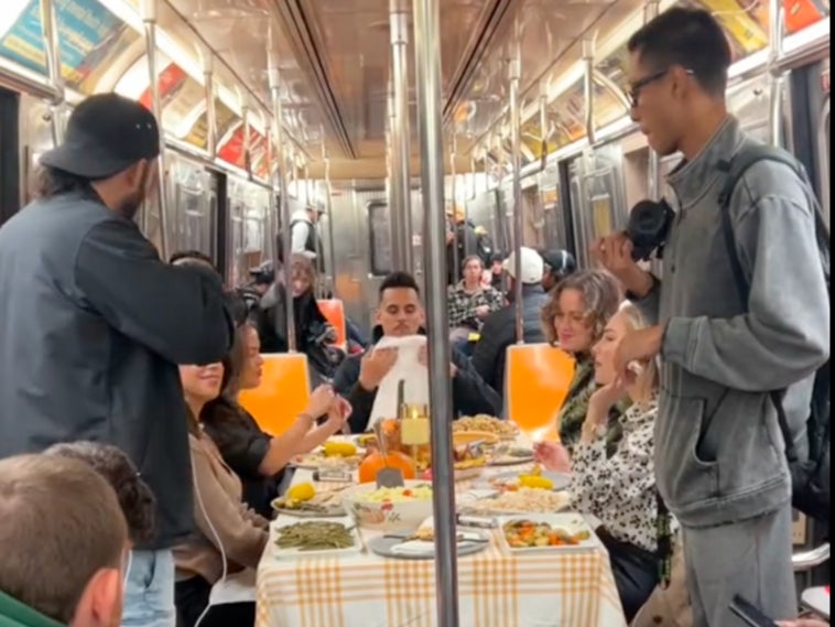 New Yorkers set up a table and ate a full Thanksgiving meal inside a train car on Thursday