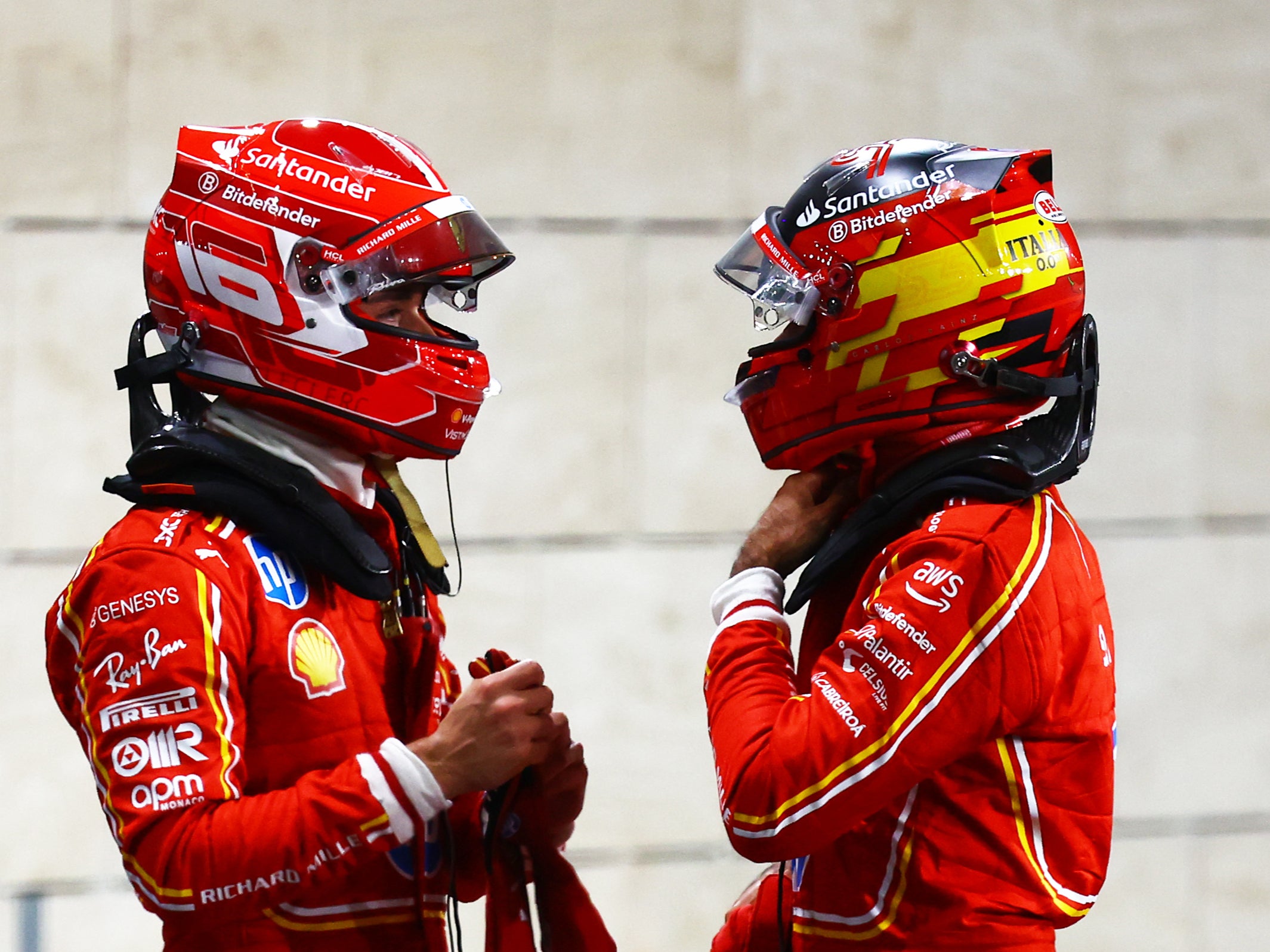 Charles Leclerc speaks with Ferrari teammate Carlos Sainz in Lusail City, Qatar