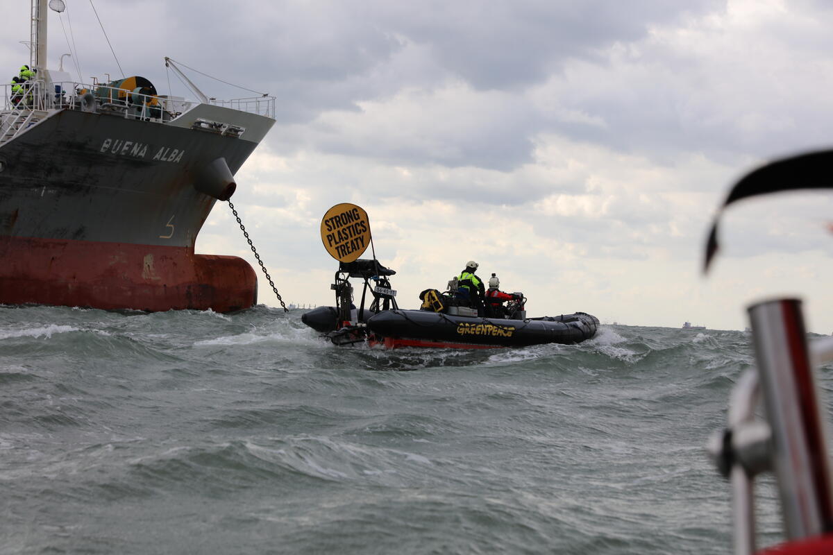 Greenpeace activists approaching a tanker on a boat off the coast of South Korea