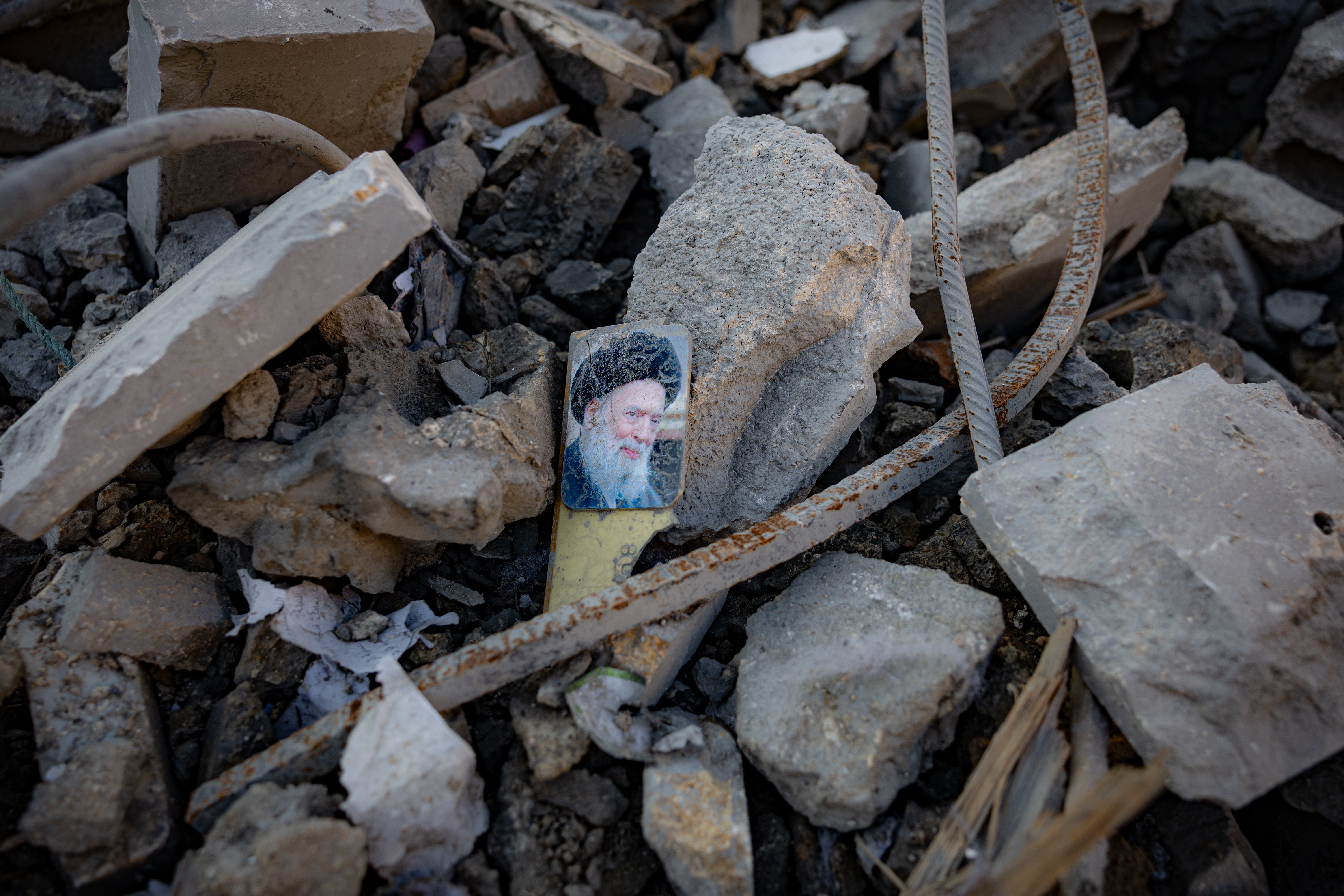 An image of Lebanon’s deceased leading Shia cleric, Grand Ayatollah Mohammed Hussein Fadlallah amid the rubble