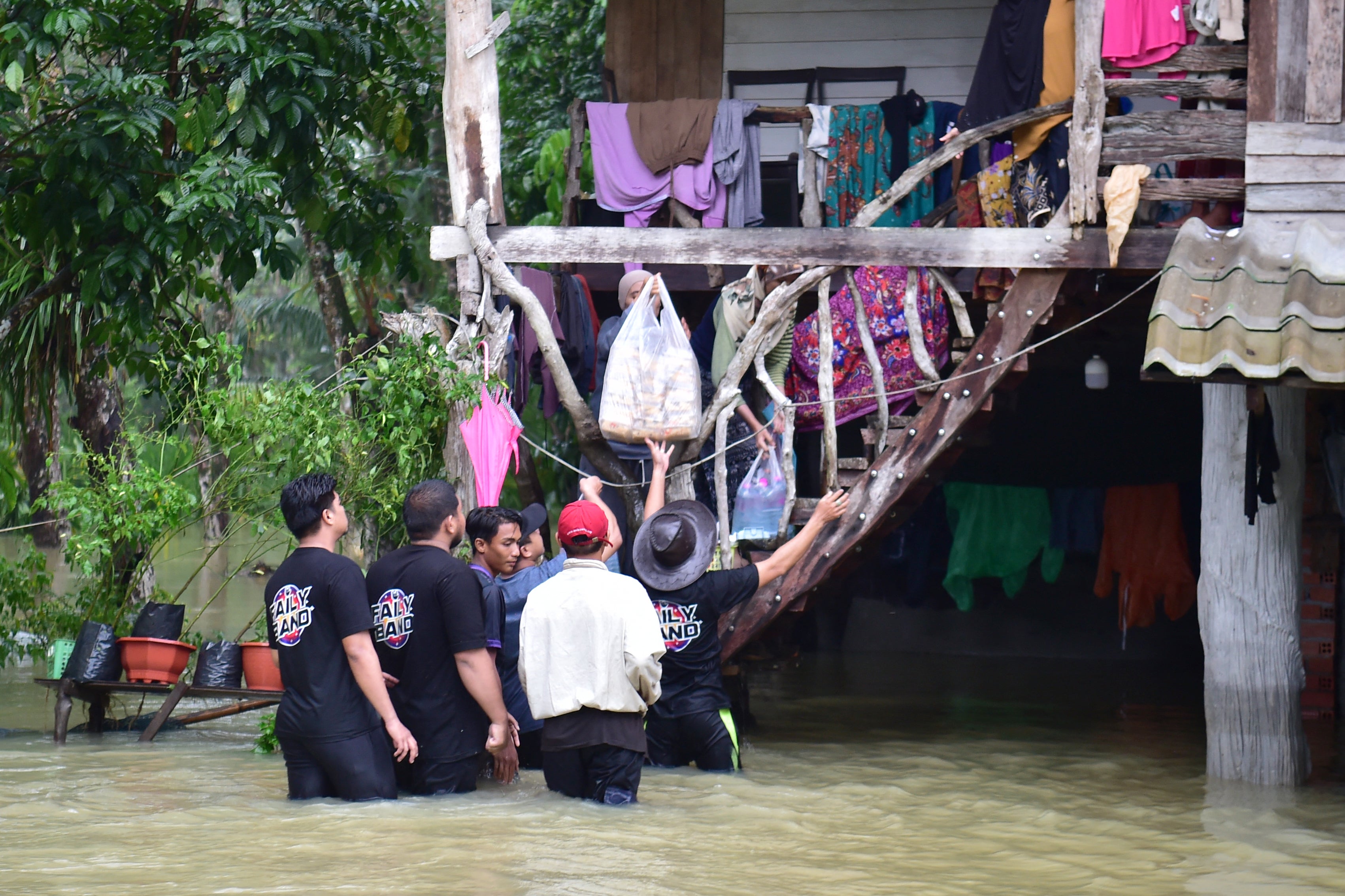 Volunteers distribute food supplies to flood-affected residents at Mueang district in Thailand’s southern province of Narathiwat