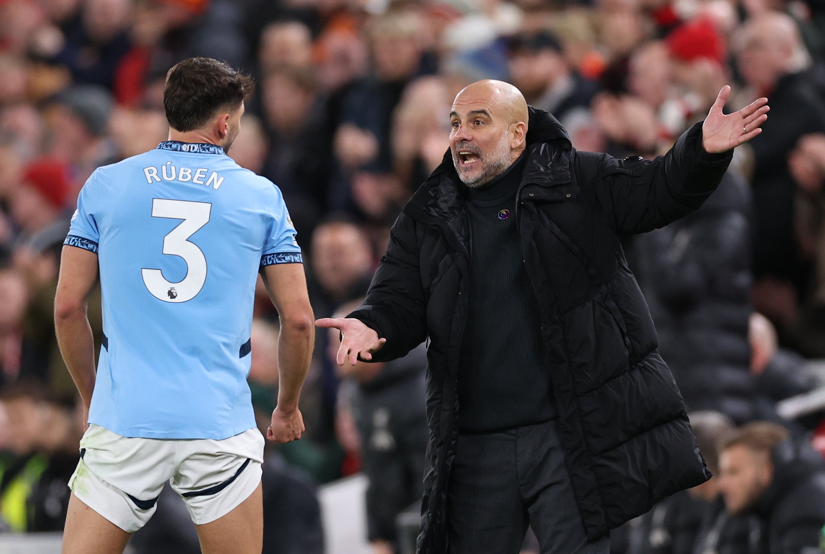 Manchester City manager Pep Guardiola talks with Ruben Dias