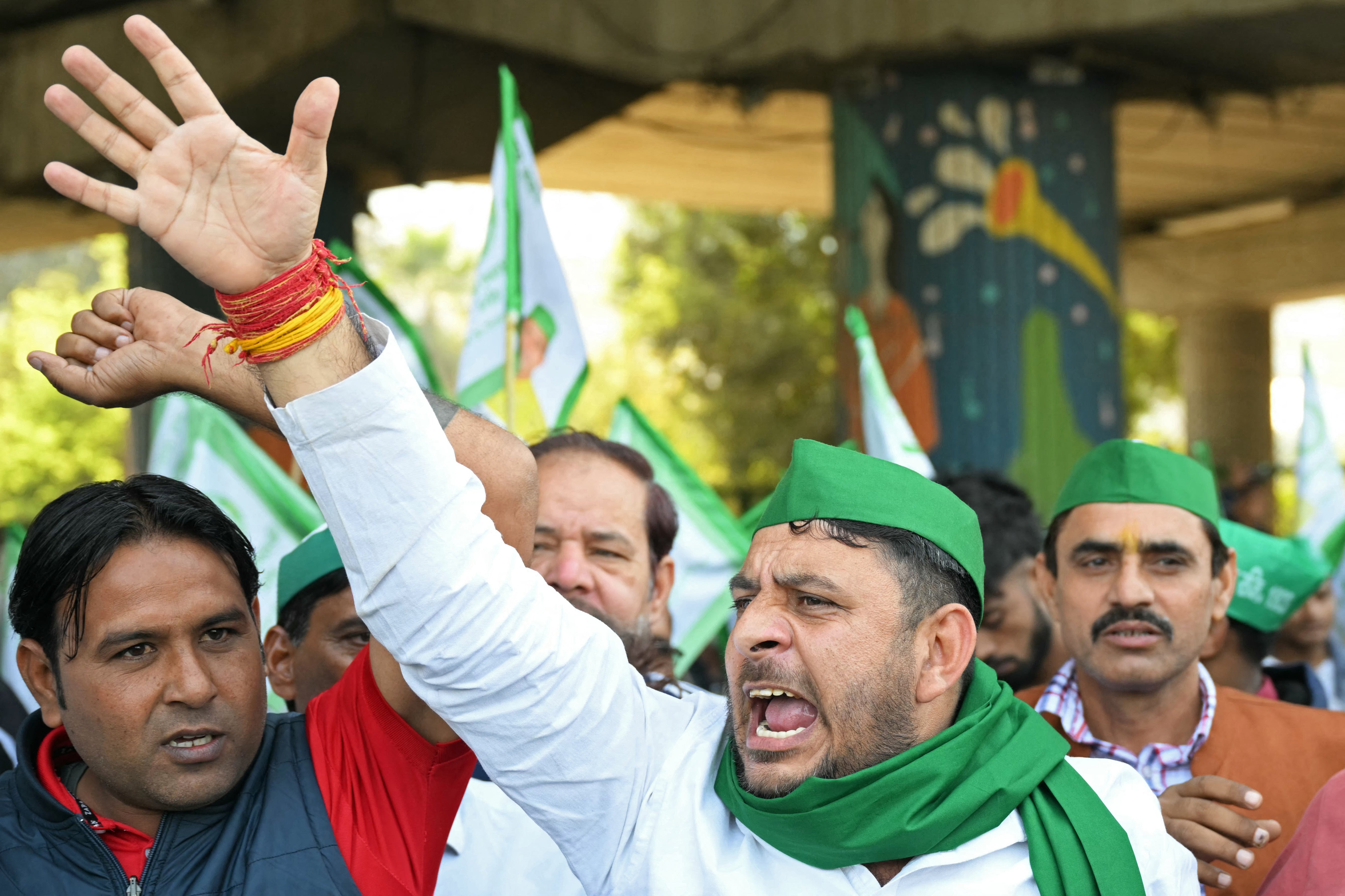 Supporters of farmer group Kisan Ekta Sangh chant slogans during a protest march in Noida