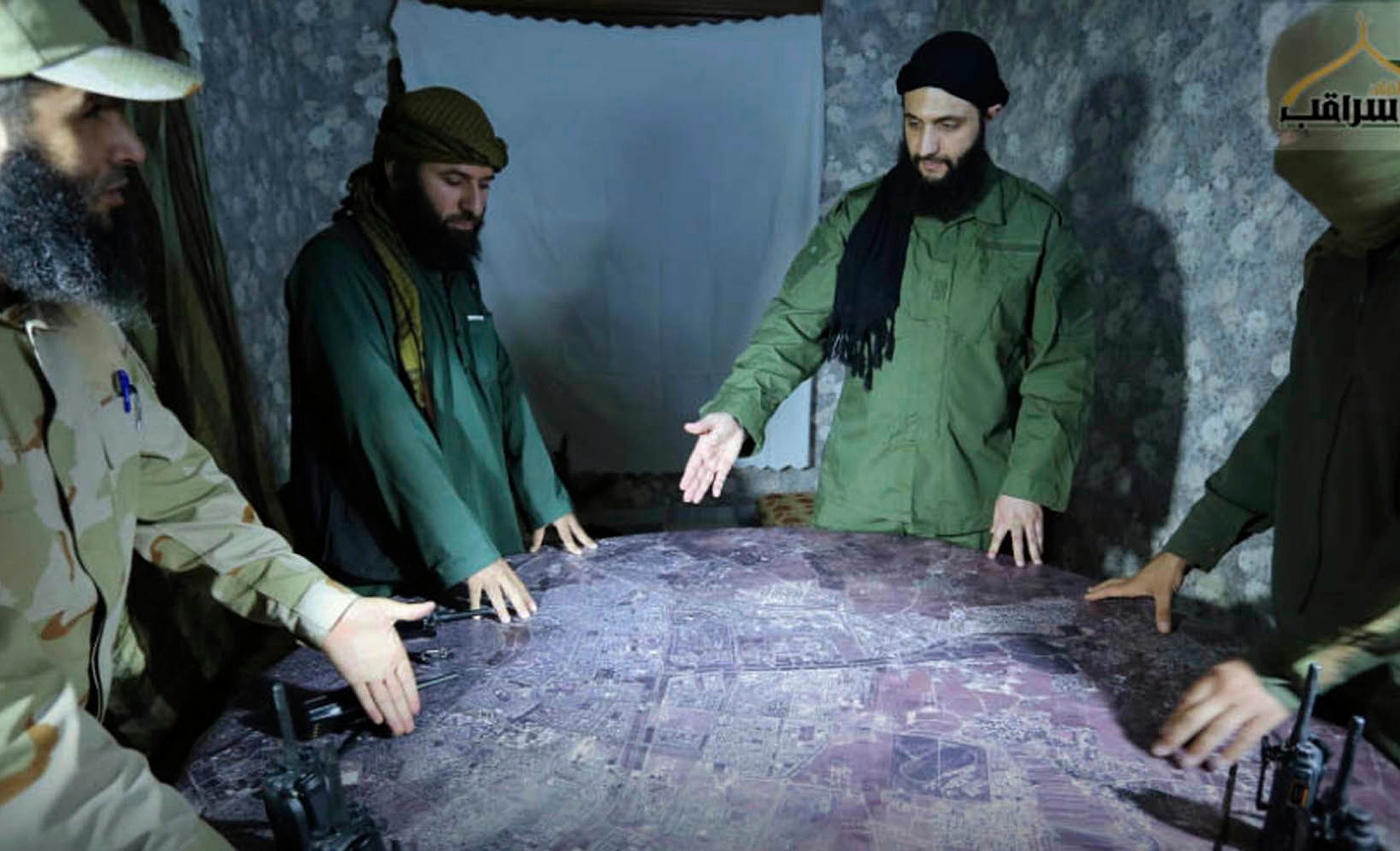 Abu Mohammed al-Golani analyses a military map of Syria