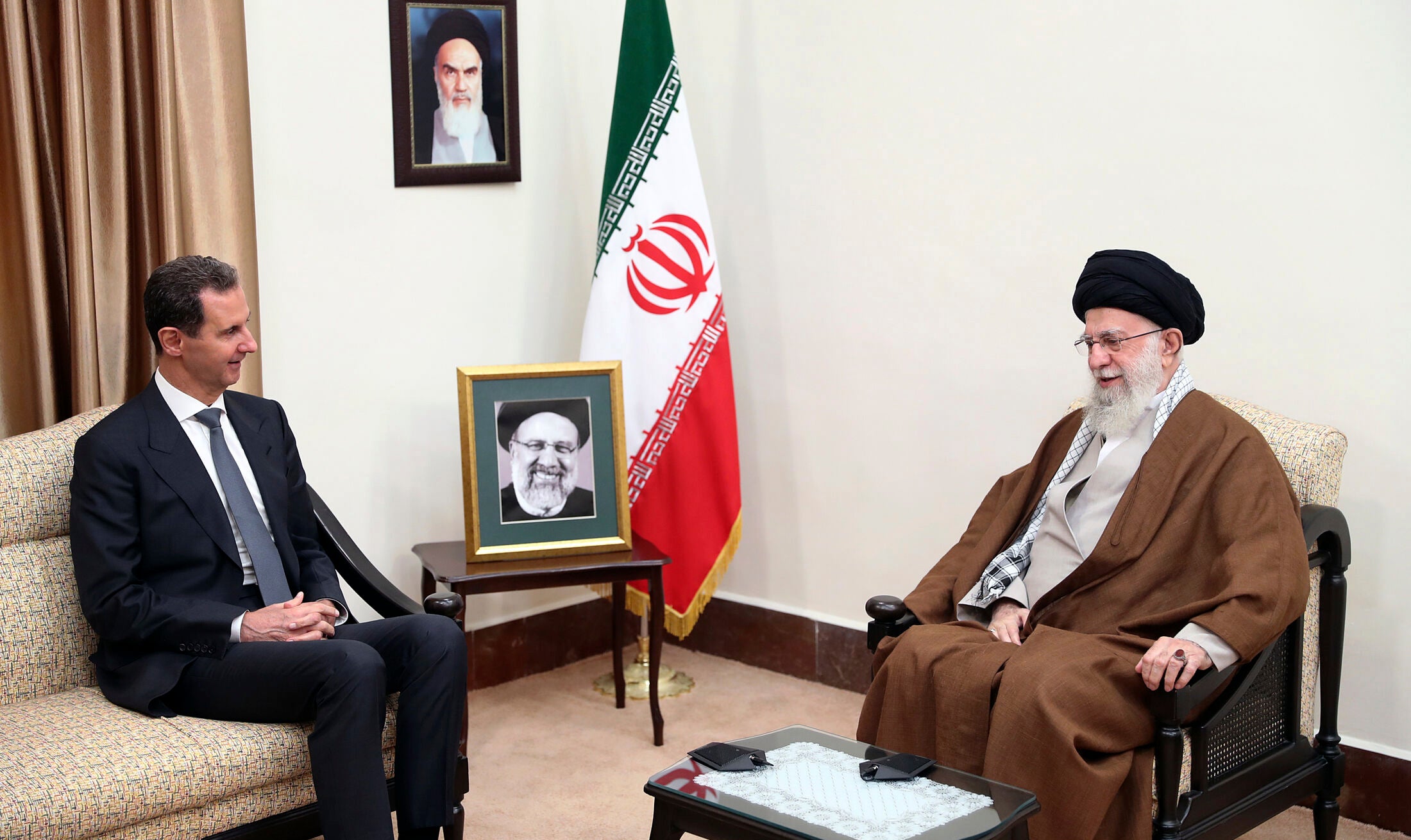 Supreme Leader Ayatollah Ali Khamenei, right, speaks with then-Syrian President Bashar Assad in a meeting in Tehran, Iran