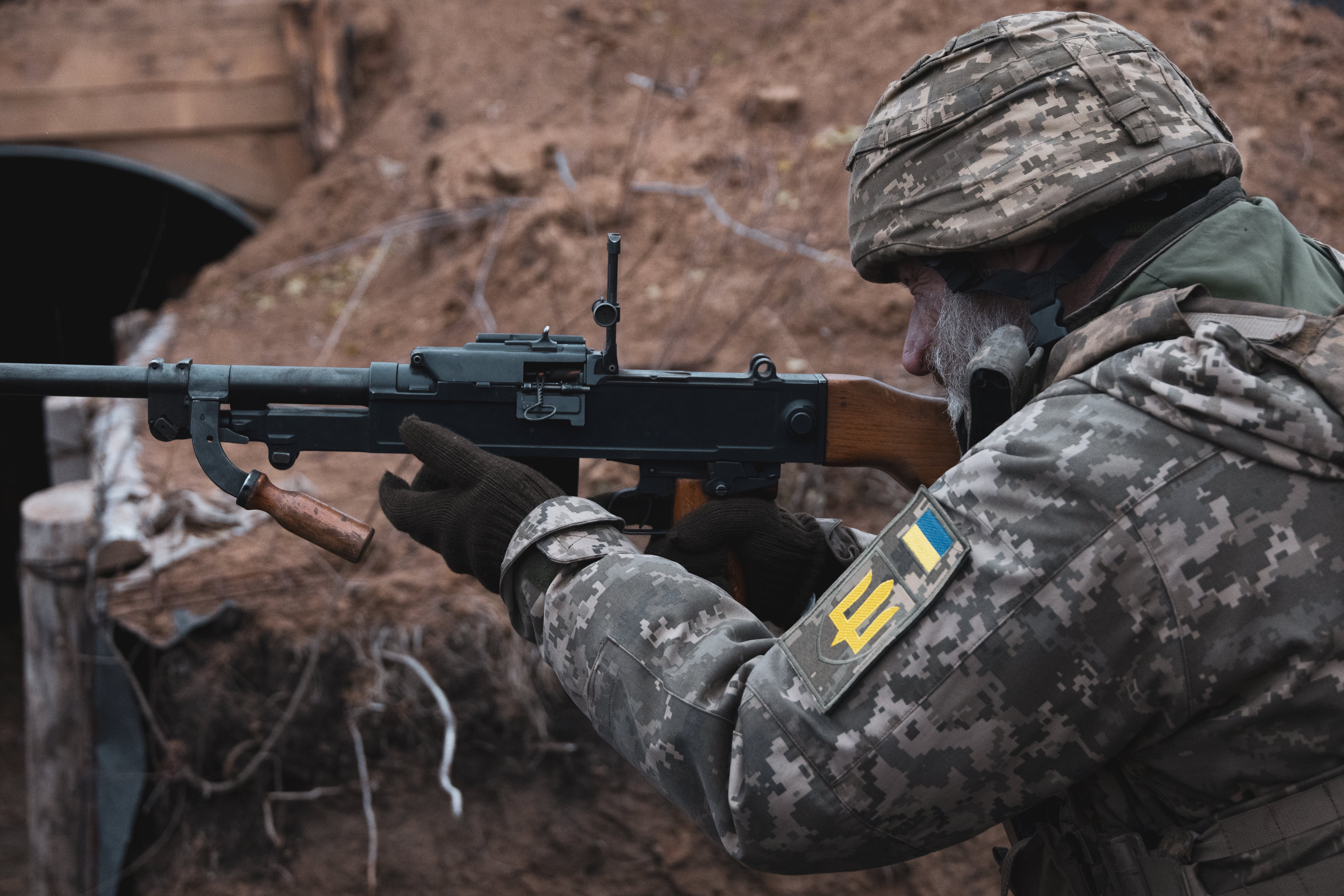 The commander of a mobile firing team of 118th motorised brigade prepares his machine gun to go on patrol and check for drones near the front line and the town of Orikhiv