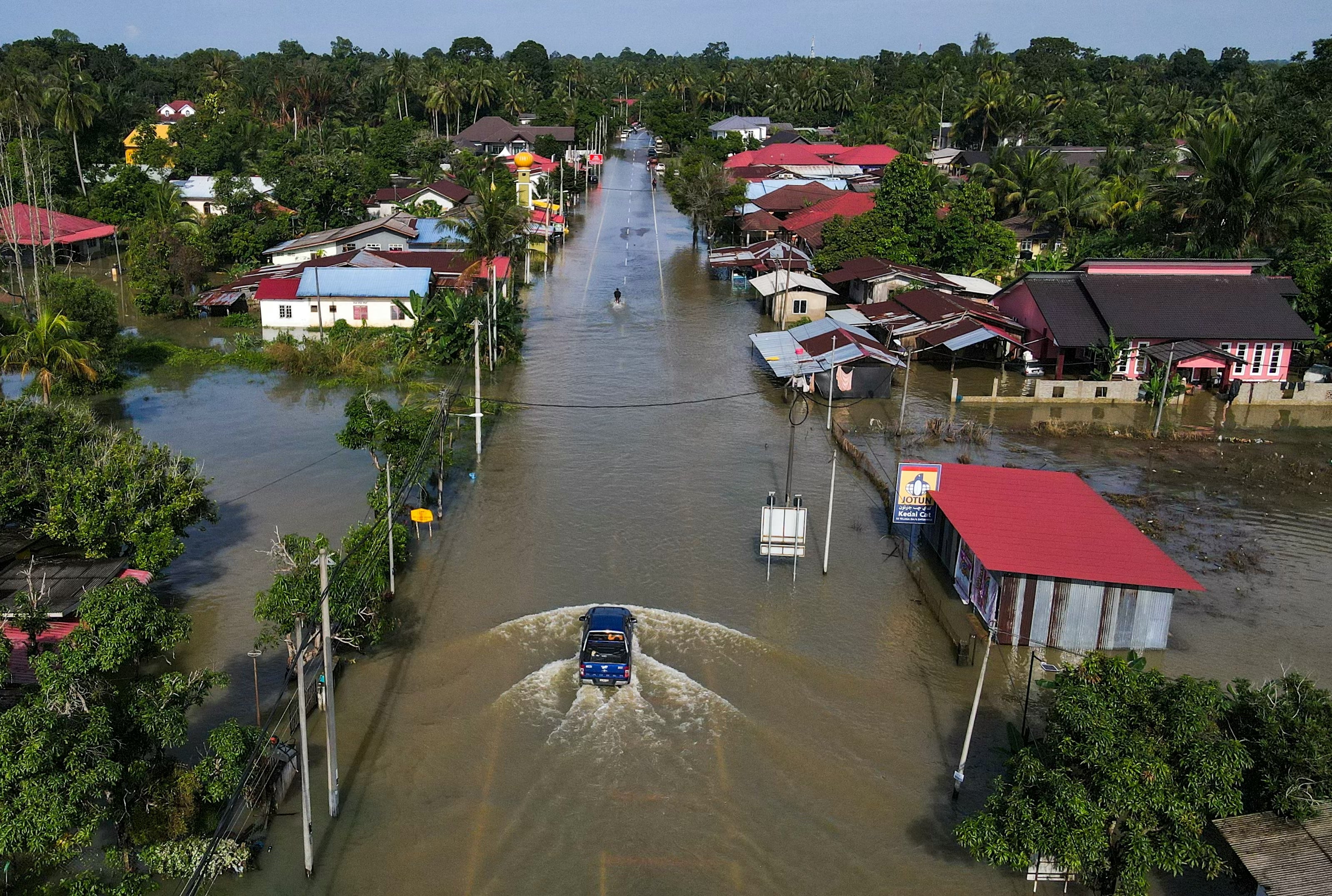 An aerial view shows houses surrounded by floodwaters after heavy rain in Tumpat, Malaysia, on 2 December 2024