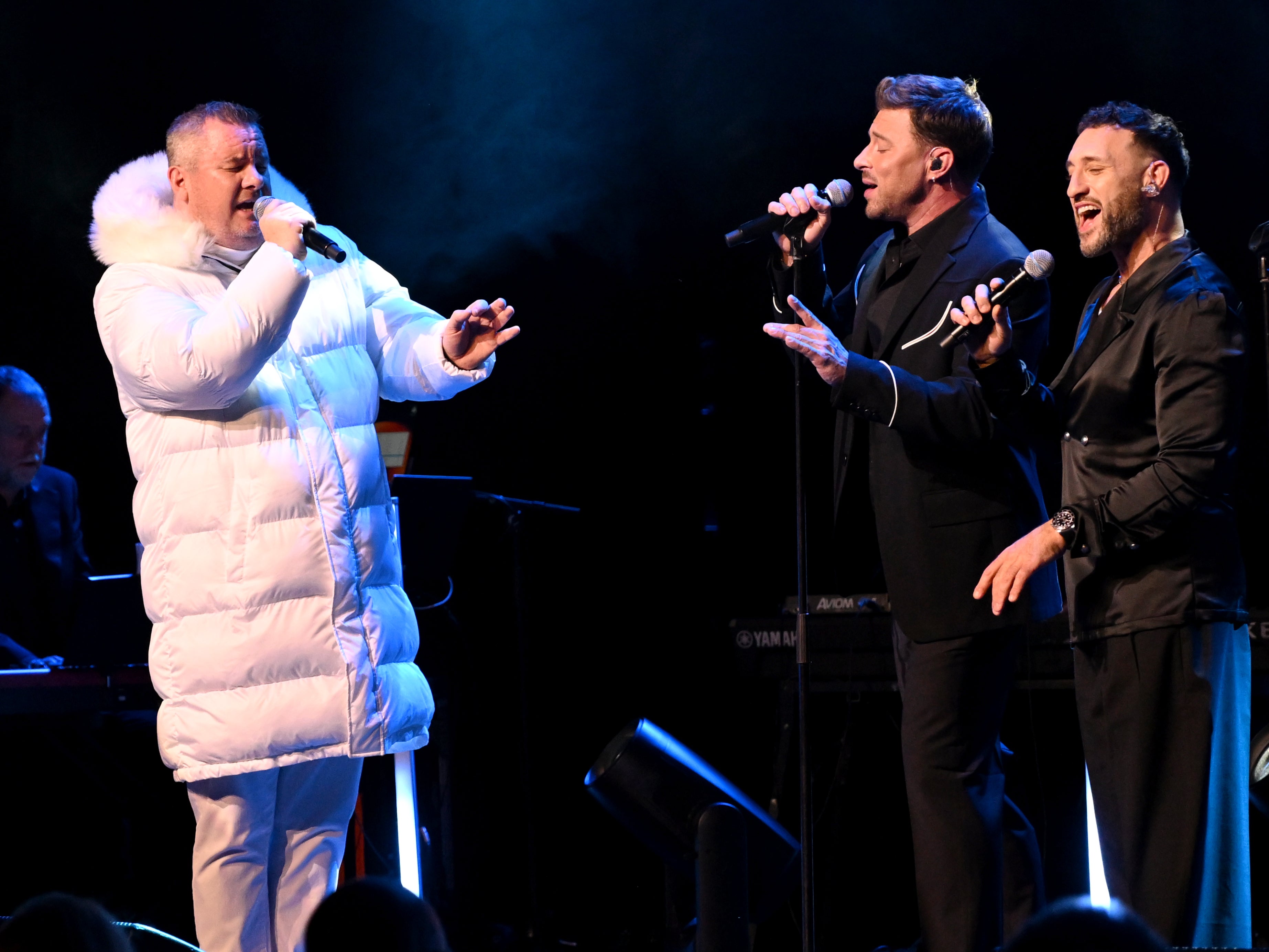 Tony Mortimer, Duncan James and Antony Costa from Blue on stage at the magic of Christmas show at London Palladium