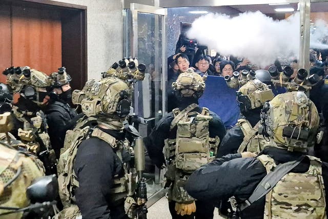 <p>Soldiers try to enter the main hall of South Korea’s National Assembly</p>