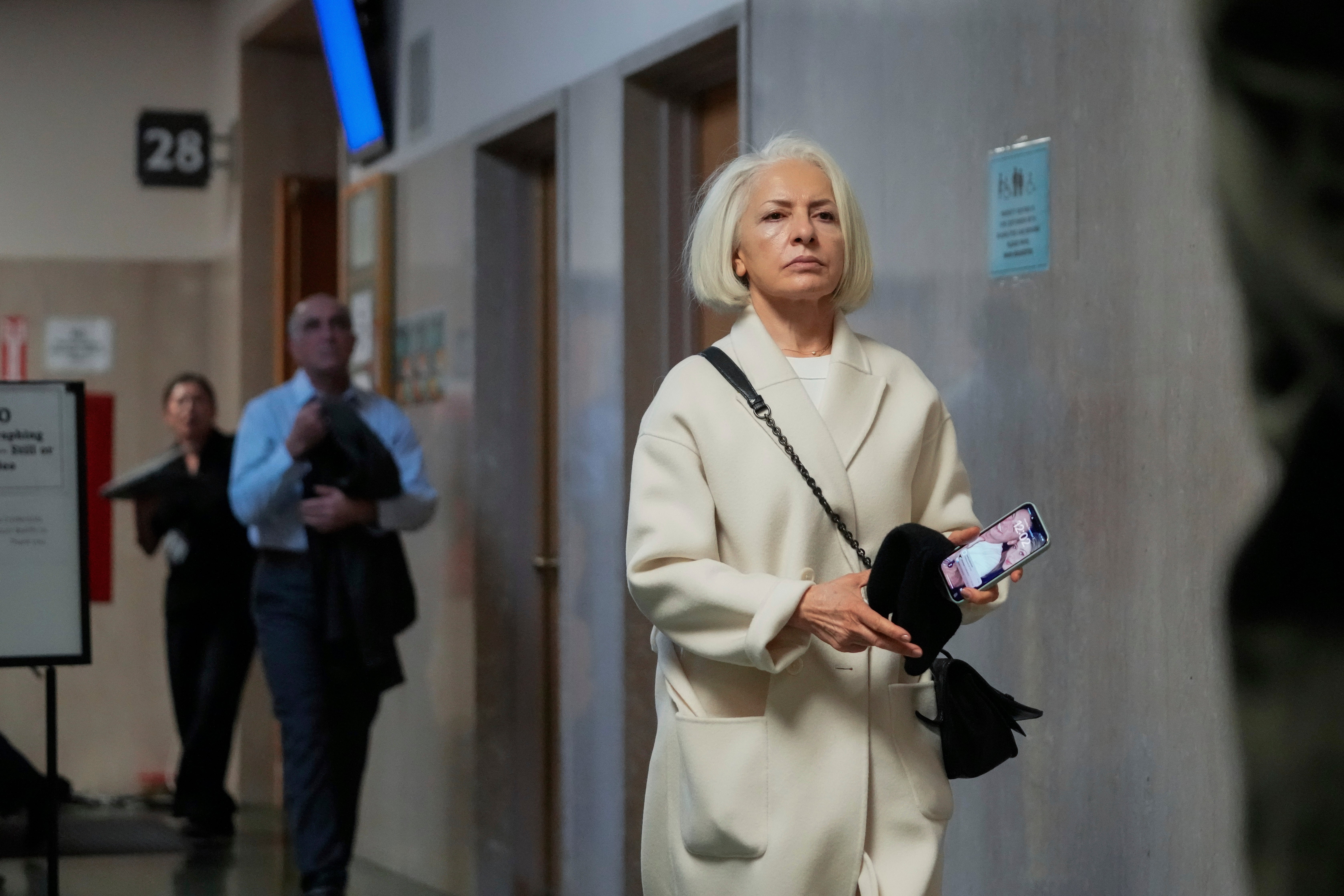 Mahnaz Tayarani, mother of Nima Momeni, walks out of the courtroom at his trial December 2. Momeni testified the killing was in self-defense