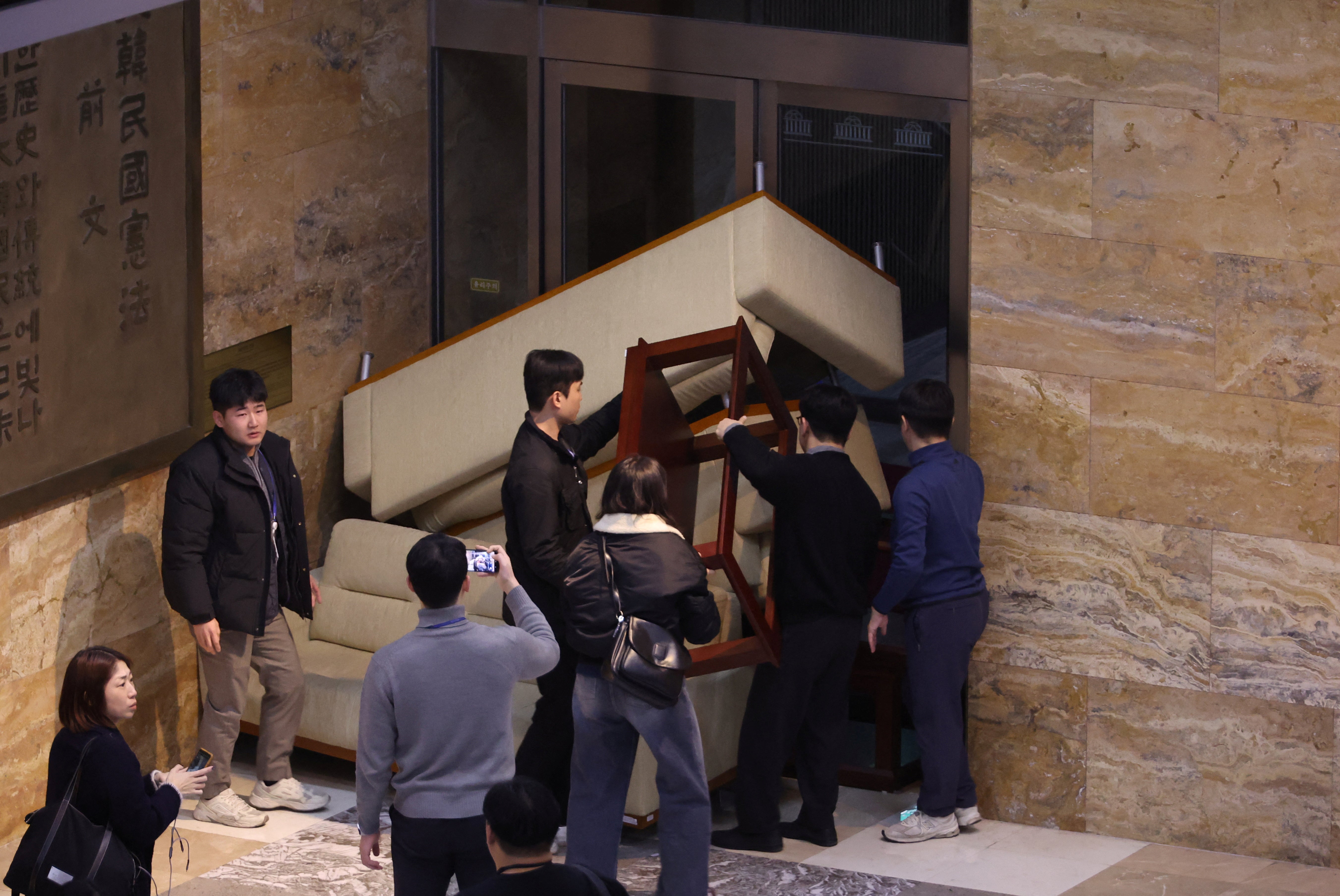 Opposition party workers barricade a door in the National Assembly building