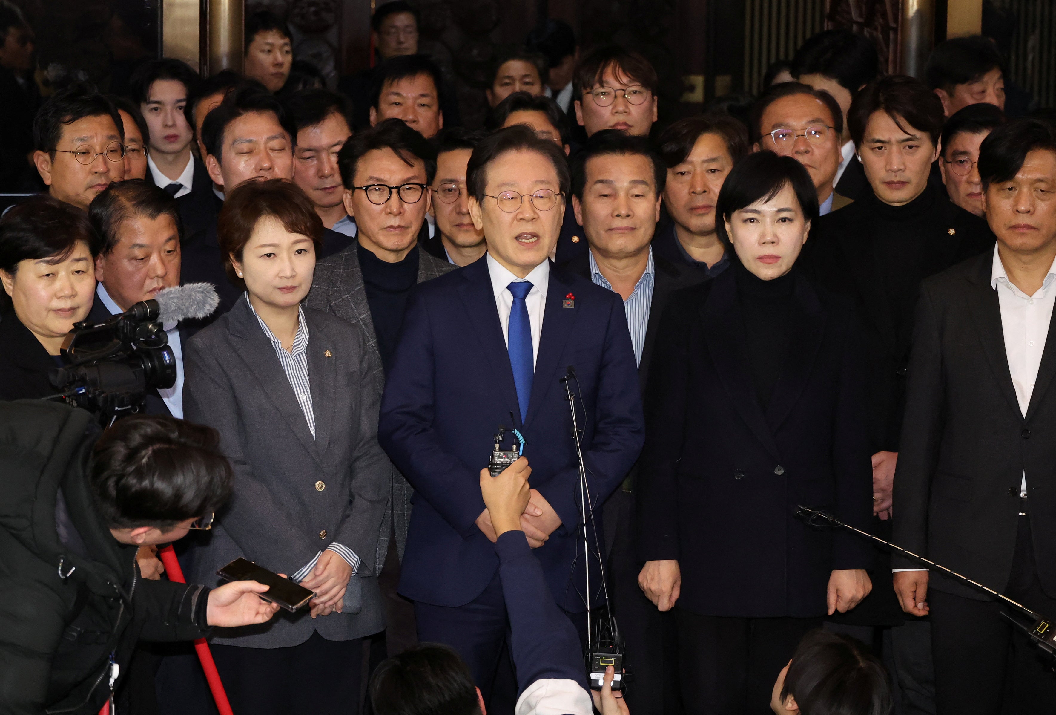 South Korea's main opposition Democratic Party leader Lee Jae-myung speak to media after parliament passed a motion requiring the martial law be lifted