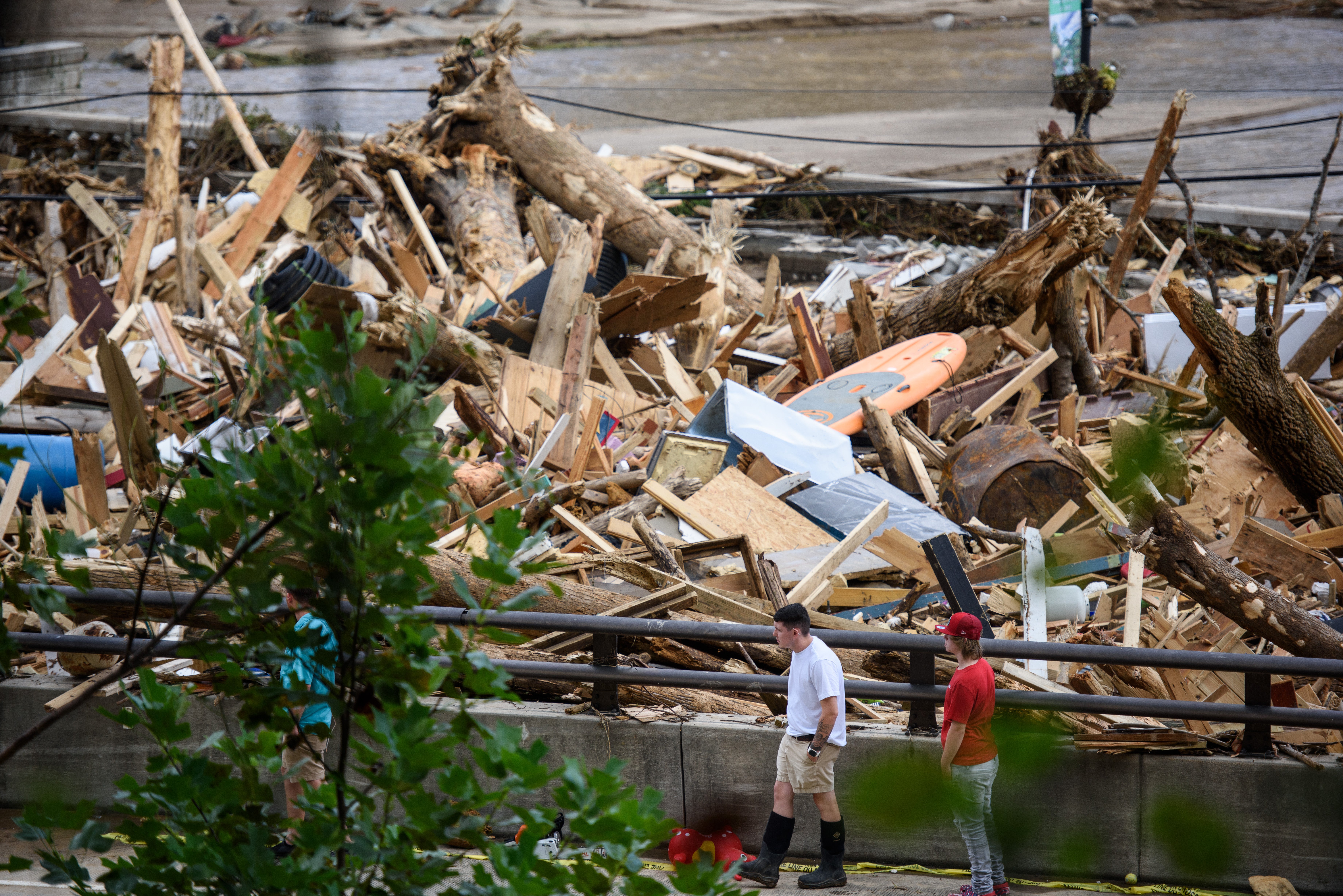 The Rocky Broad River flows into North Carolina’s Lake Lure and overflows the town with debris after heavy rains from Hurricane Helene last September. Officials say the amount of debris they’ve collected could fill thousands of Olympic-sized swimming pools