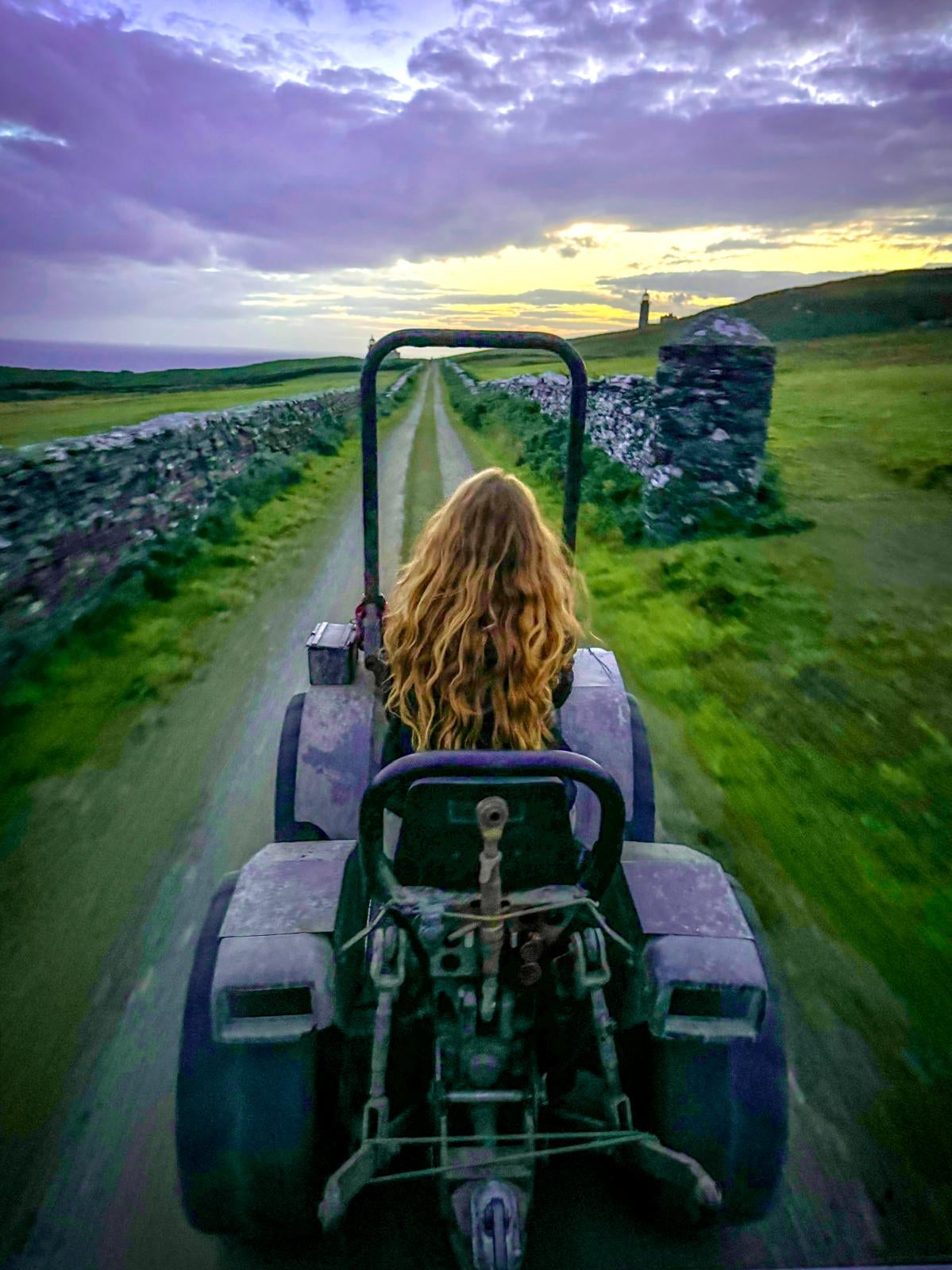 Chloe on a tractor at dusk