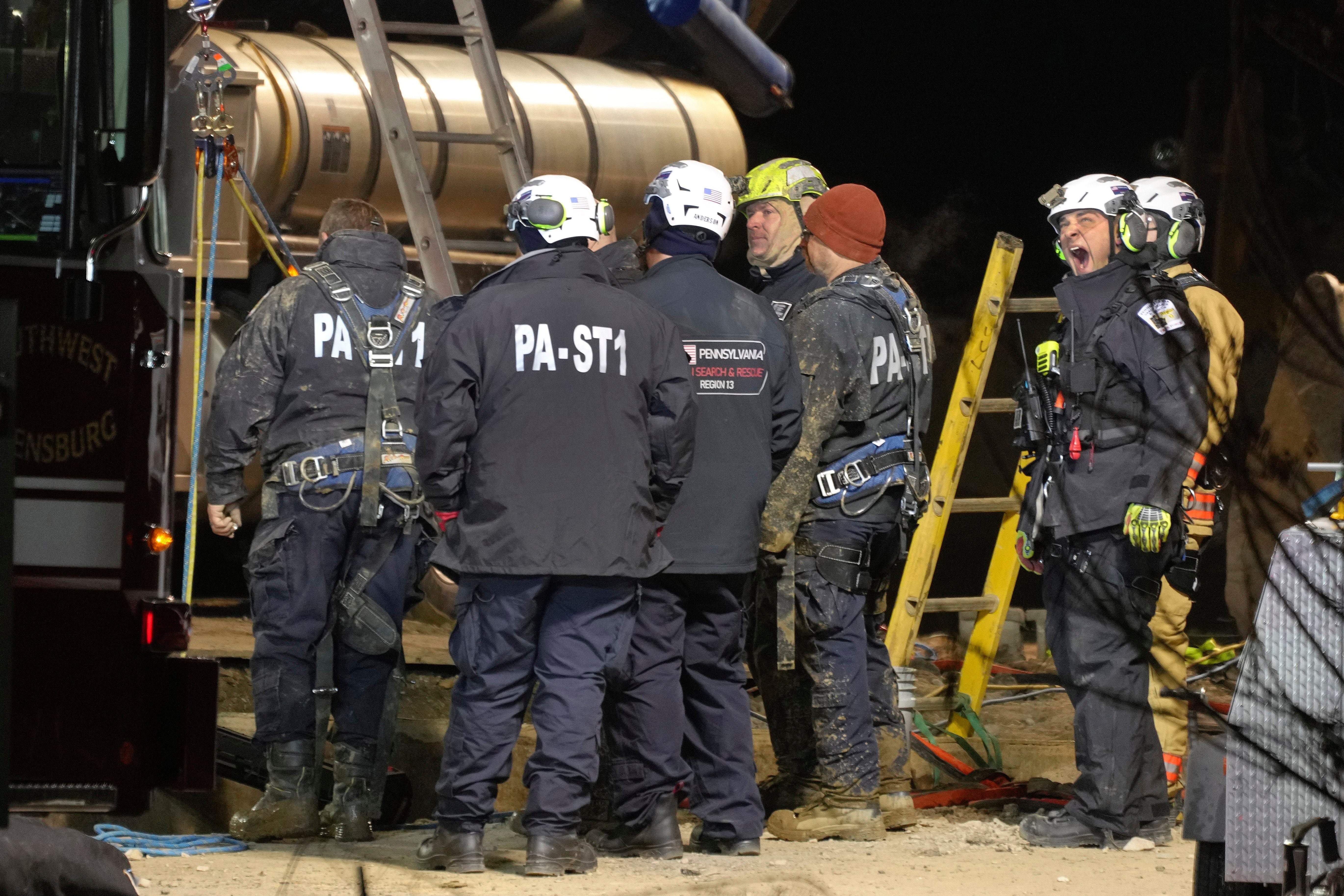 Rescue workers search in a sinkhole for Elizabeth Pollard, who disappeared while looking for her cat