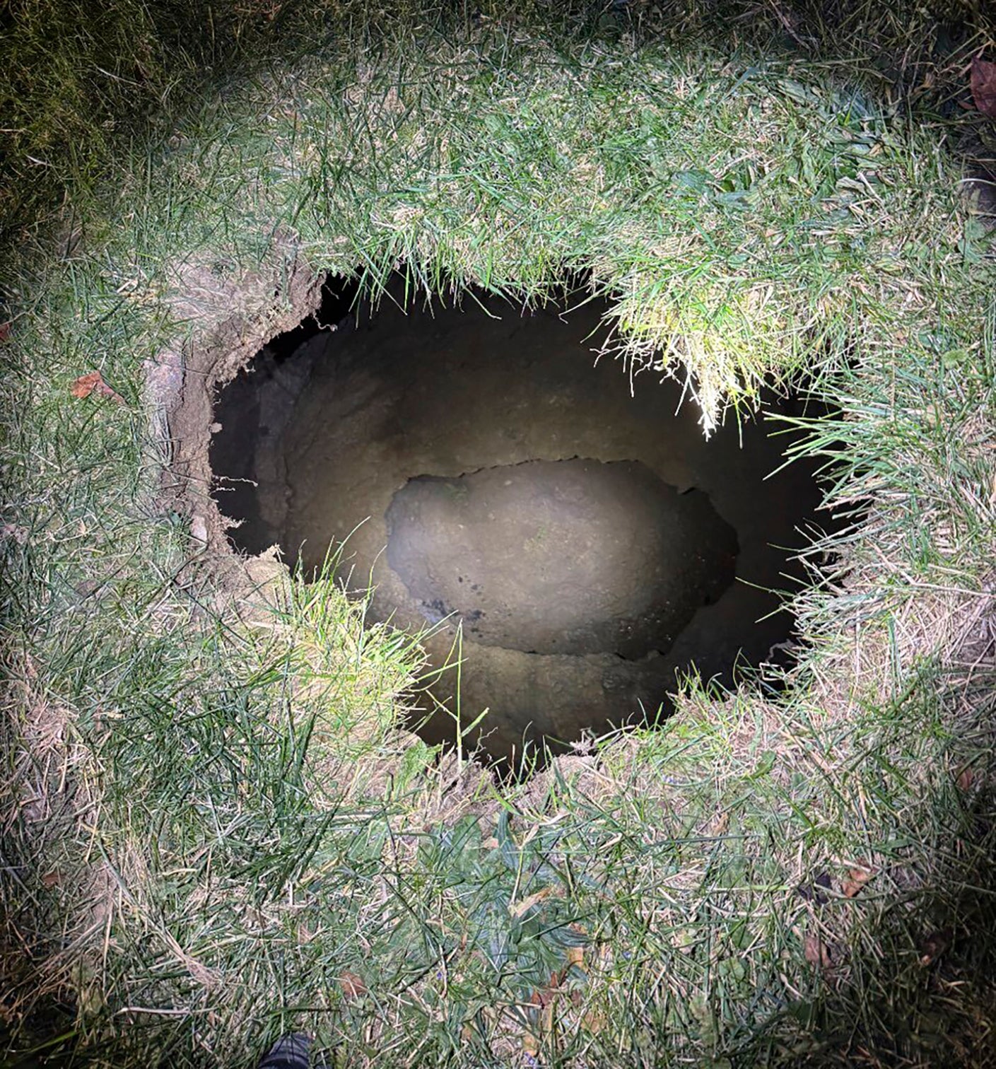 This Tuesday, Dec. 3, 2024. image provided by the Pennsylvania State Police shows the top of a sinkhole in the village of Marguerite, Pa., where rescuers were searching for a woman who disappeared