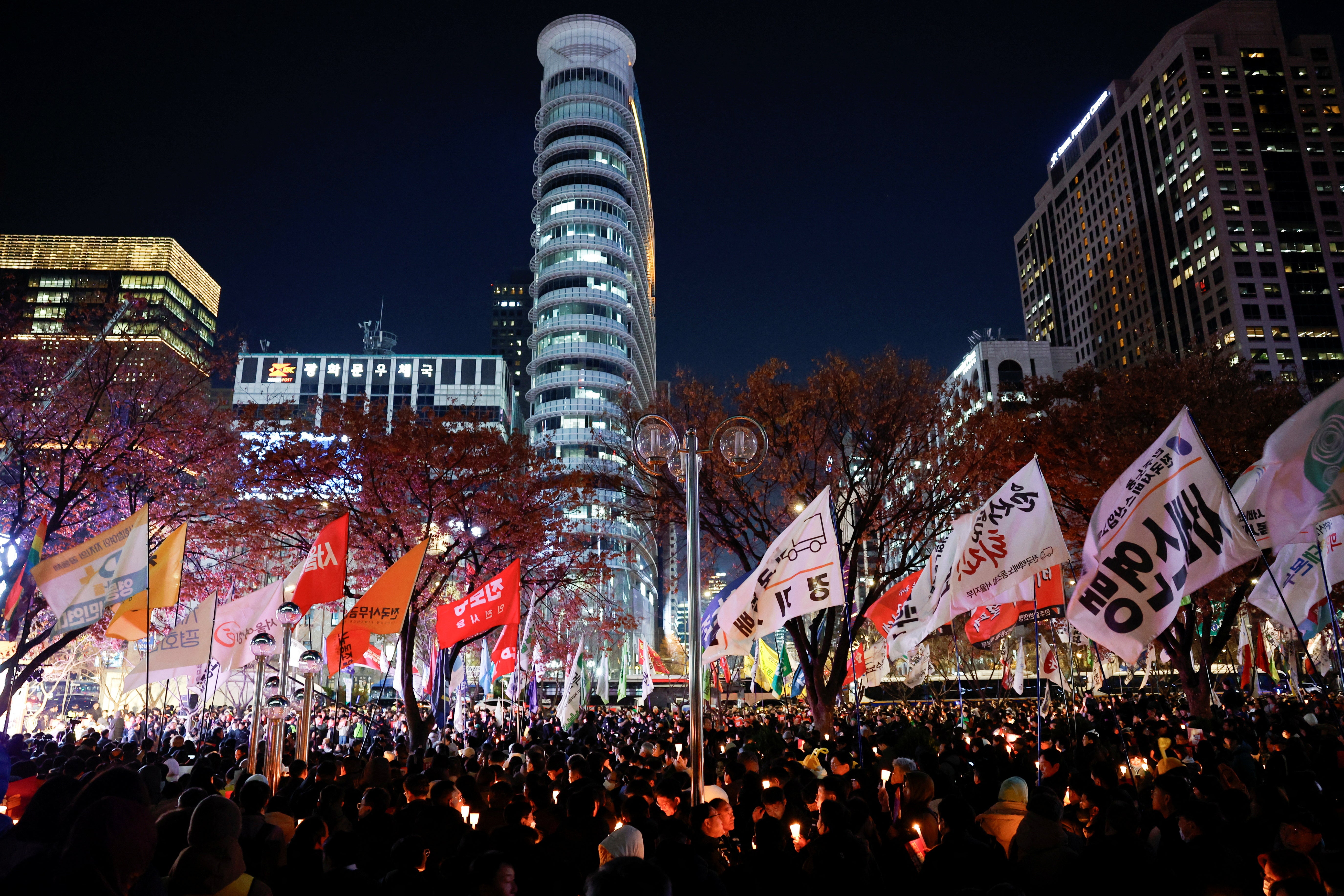 People attend a candlelight vigil condemning South Korean President Yoon Suk Yeol’s surprise declaration of martial law