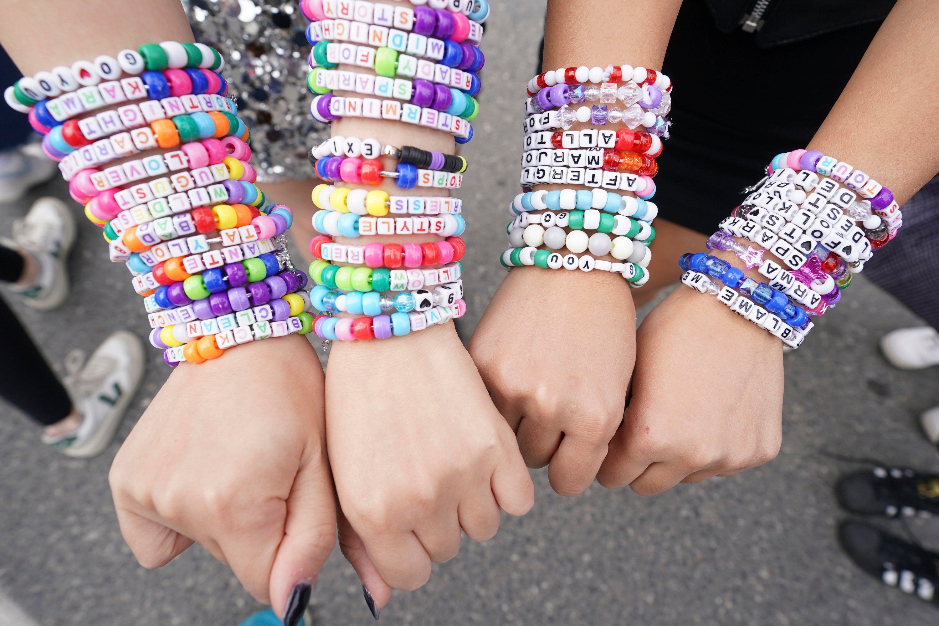 Taylor Swift fans show off their friendship bracelets at a show in Toronto, November 2024