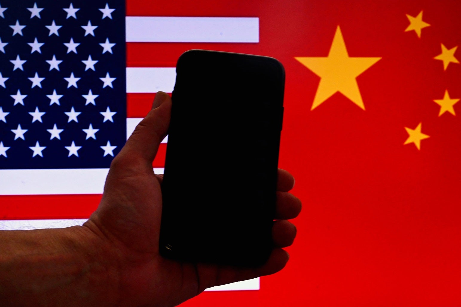 An iPhone in front of a US flag and Chinese flag background in Washington, DC, on 16 March, 2023