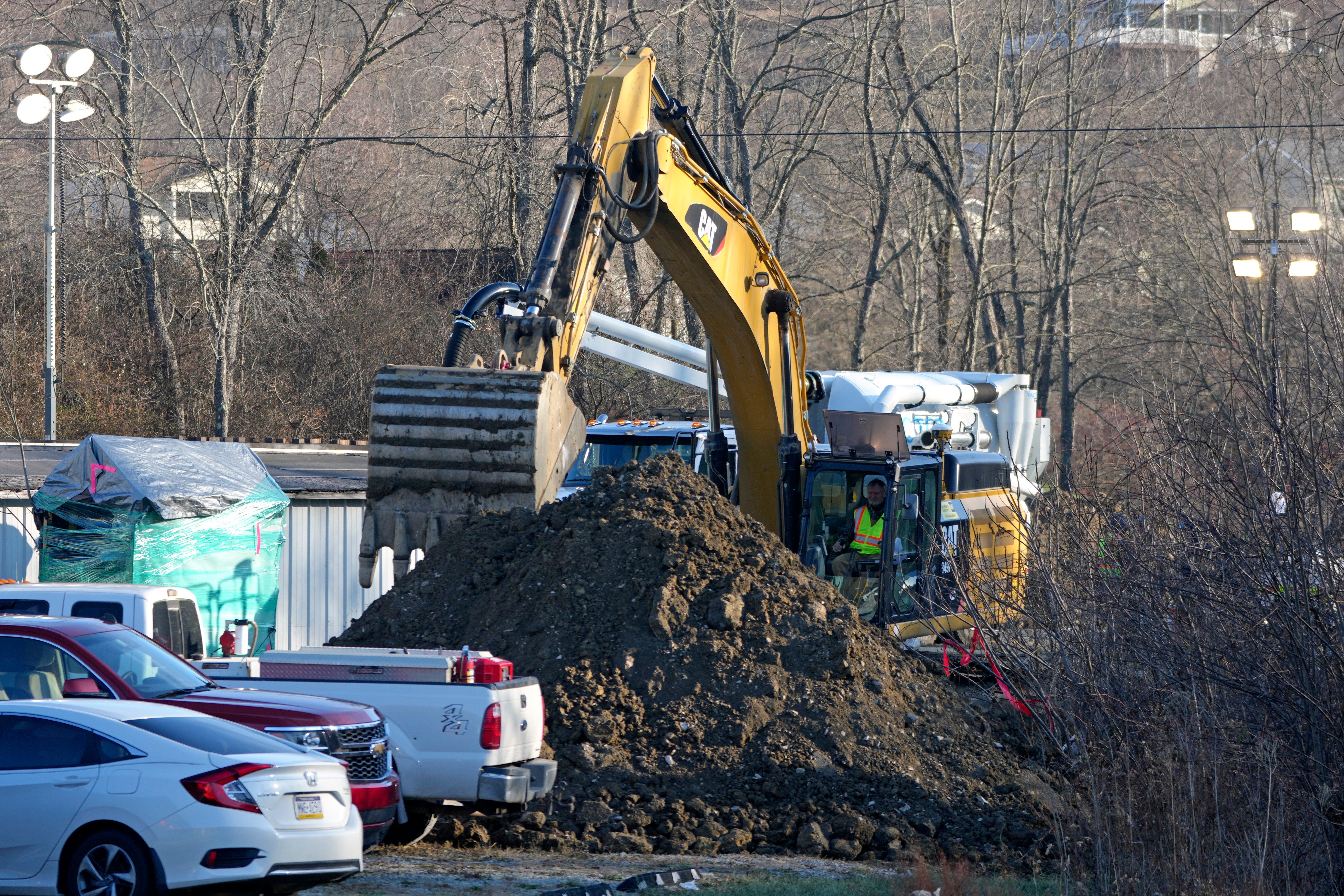 Rescue crews pictured on Wednesday morning searching the sinkhole for missing grandmother Elizabeth Pollard