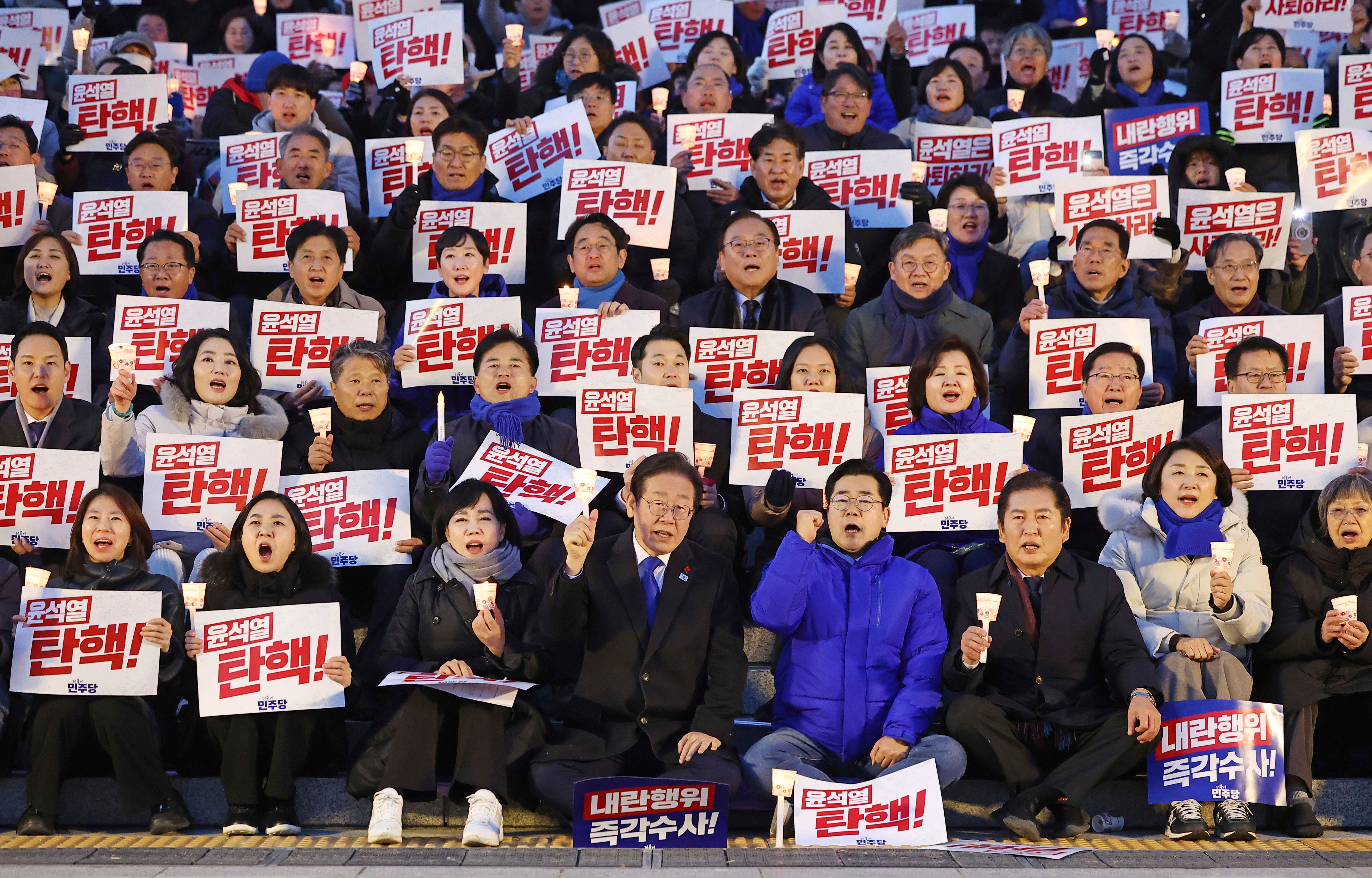 South Korea's main opposition Democratic Party leader Lee Jae-myung, bottom center left, and his party members stage a rally against the President Yoon Suk Yeol at the National Assembly in Seoul, South Korea, Wednesday, 4 Dec 2024