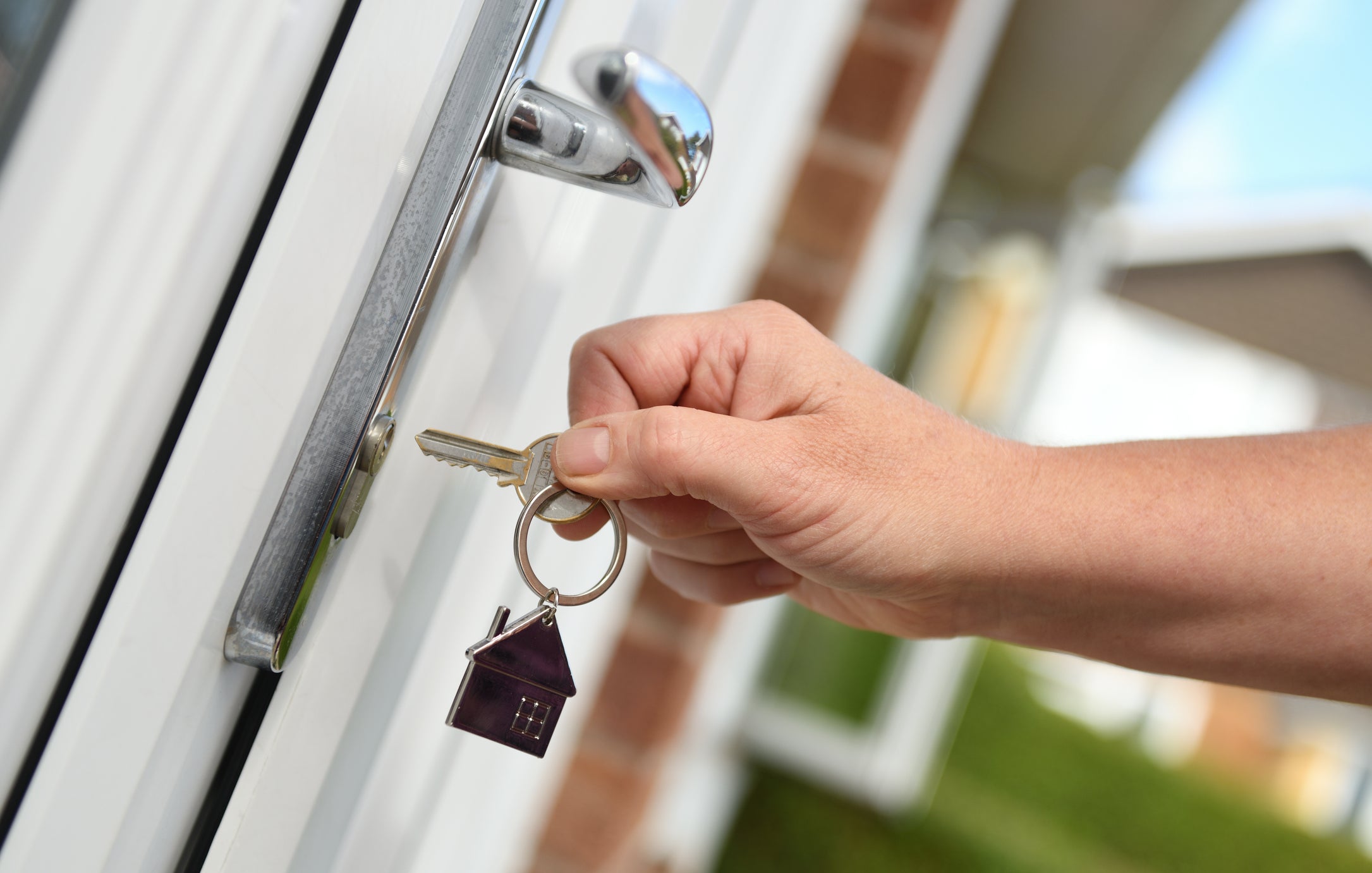 A man opens the door to a house with a key. New research from Oxford University has found owning a home in early adult life added approximately four months to the lives of male Americans born in the early twentieth century