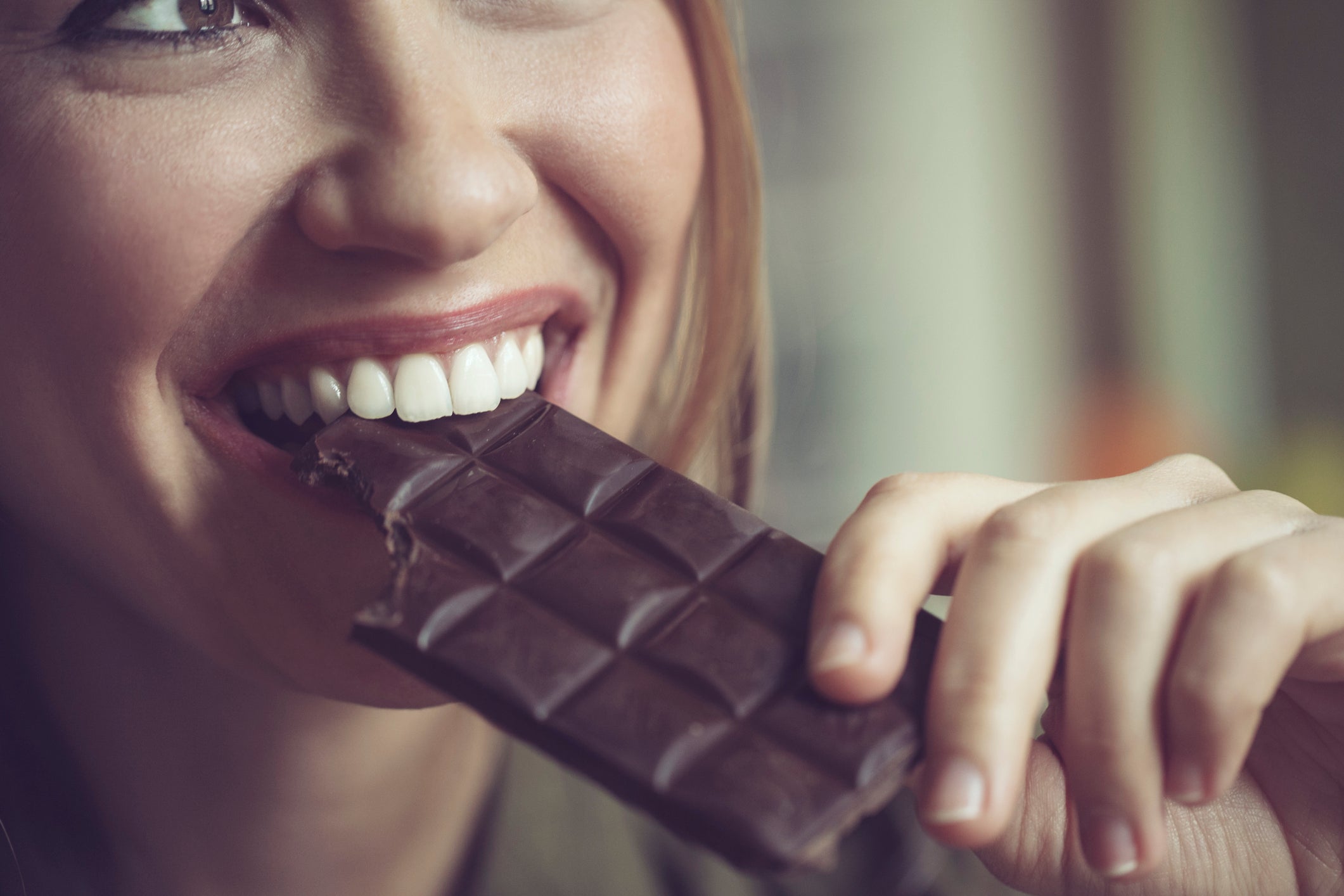 A woman eats dark chocolate. More than 38 million Americans live with diabetes