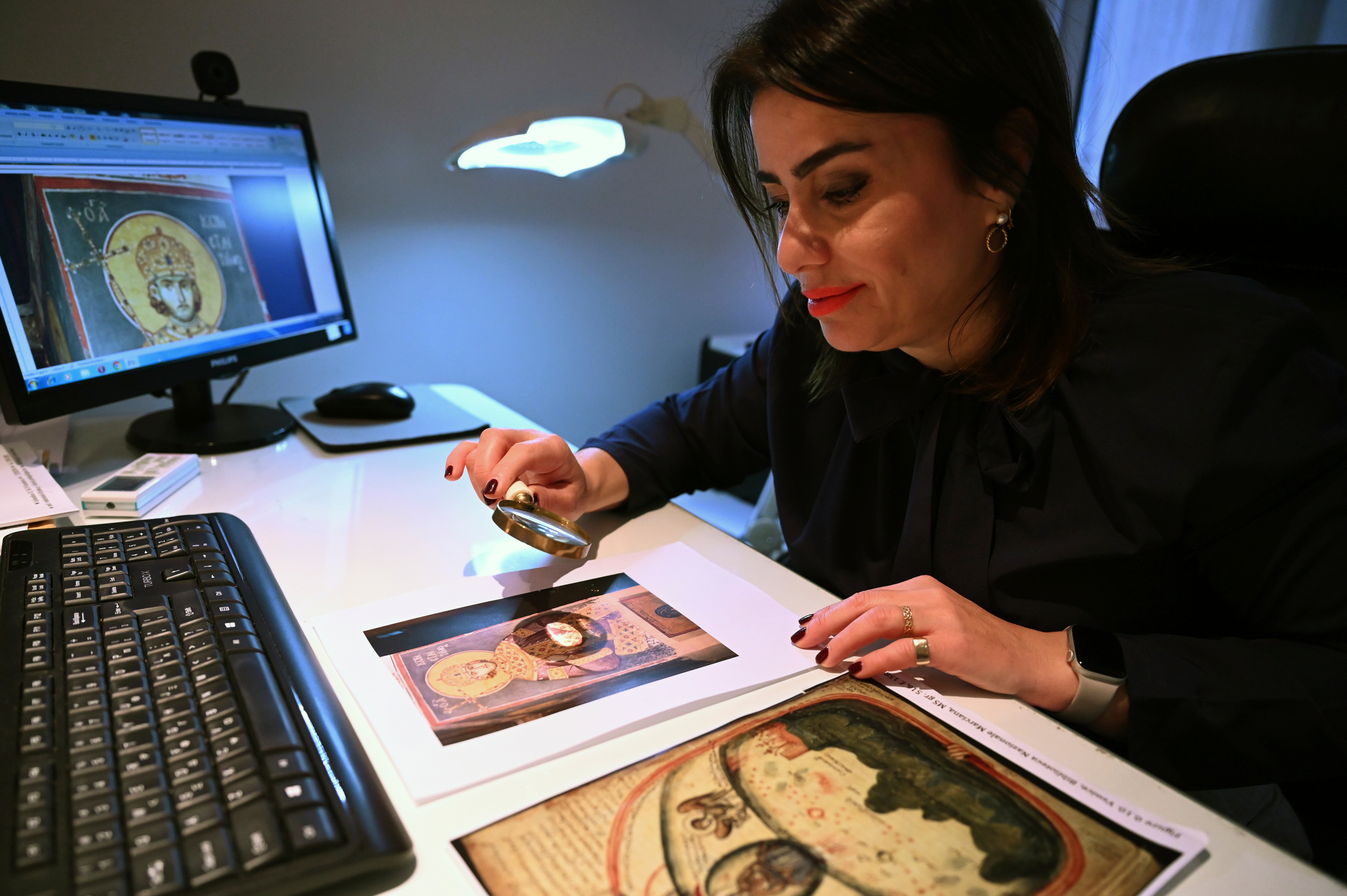 Christina Sotirakoglou a handwriting expert, observes Byzantine paintings based on photographs print