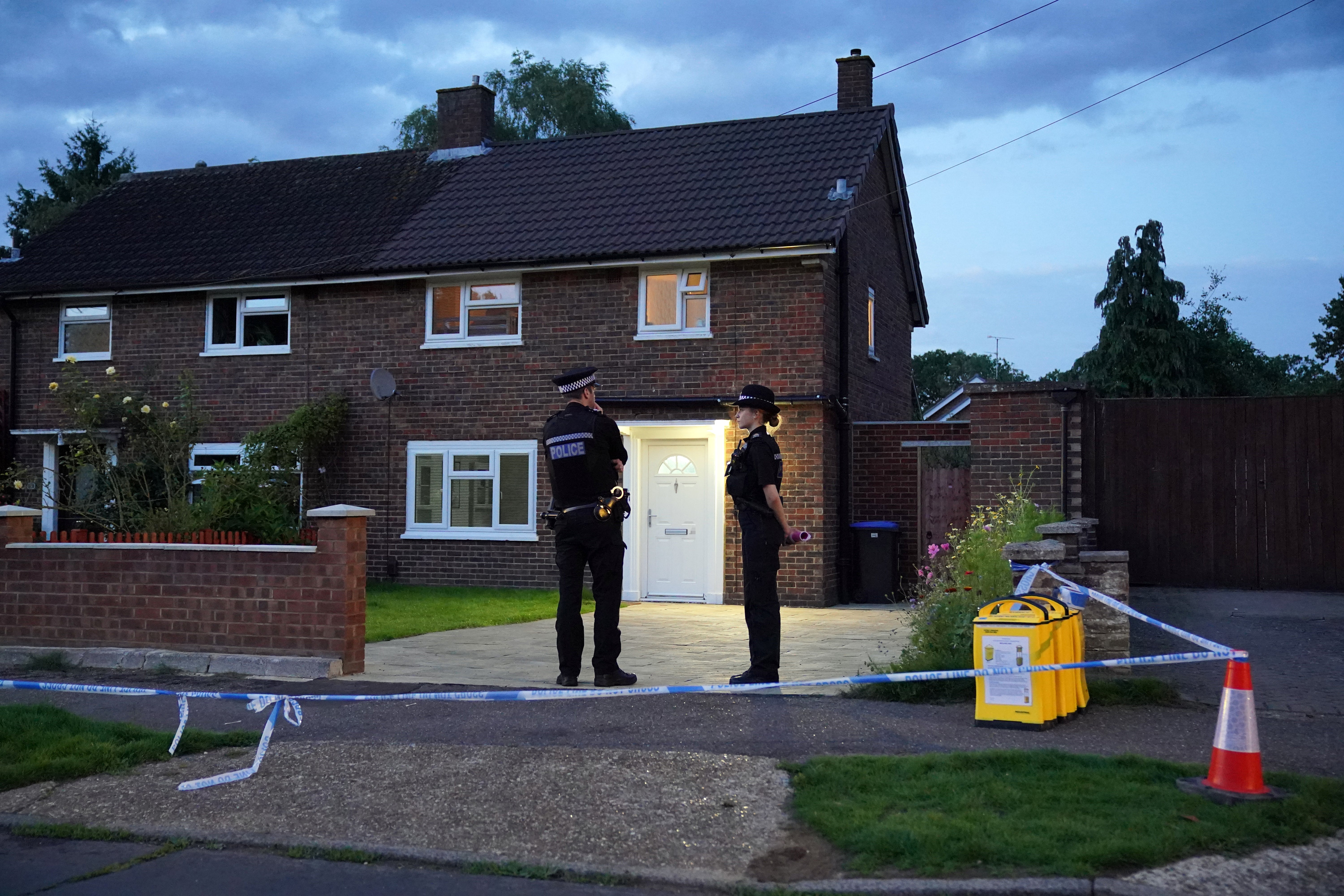 Police officers stand outside Sharif’s house on Hammond Road in Woking on 10 August 2023