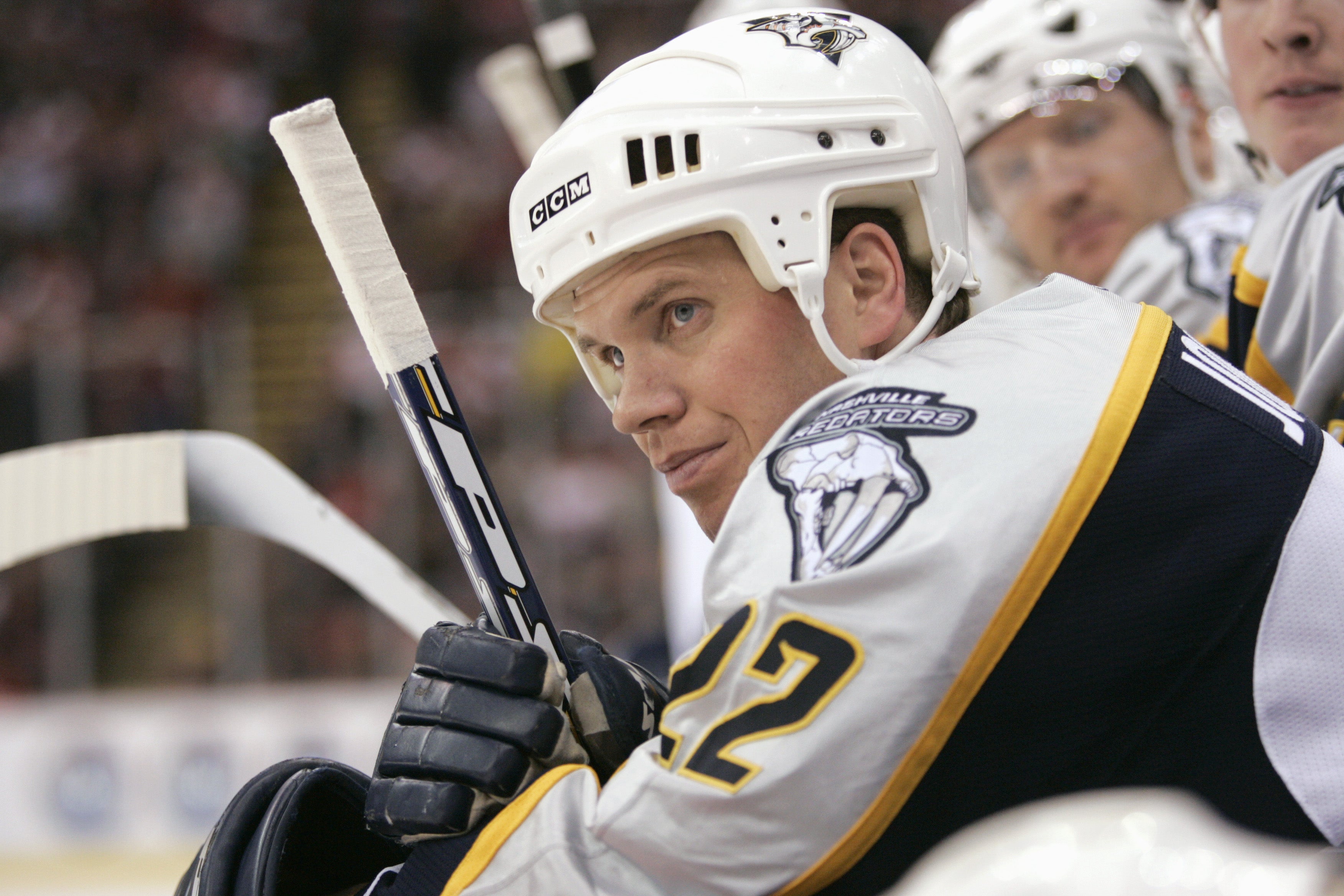 Greg Johnson, of the Nashville Predators, looks on from the bench during the game against the Detroit Red Wings in March 2006. Johnson was posthumously diagnosed with the neurodegenerative disease known as CTE. Now, a new study has found that odds of developing the disease increased by 34 percent with each year men played