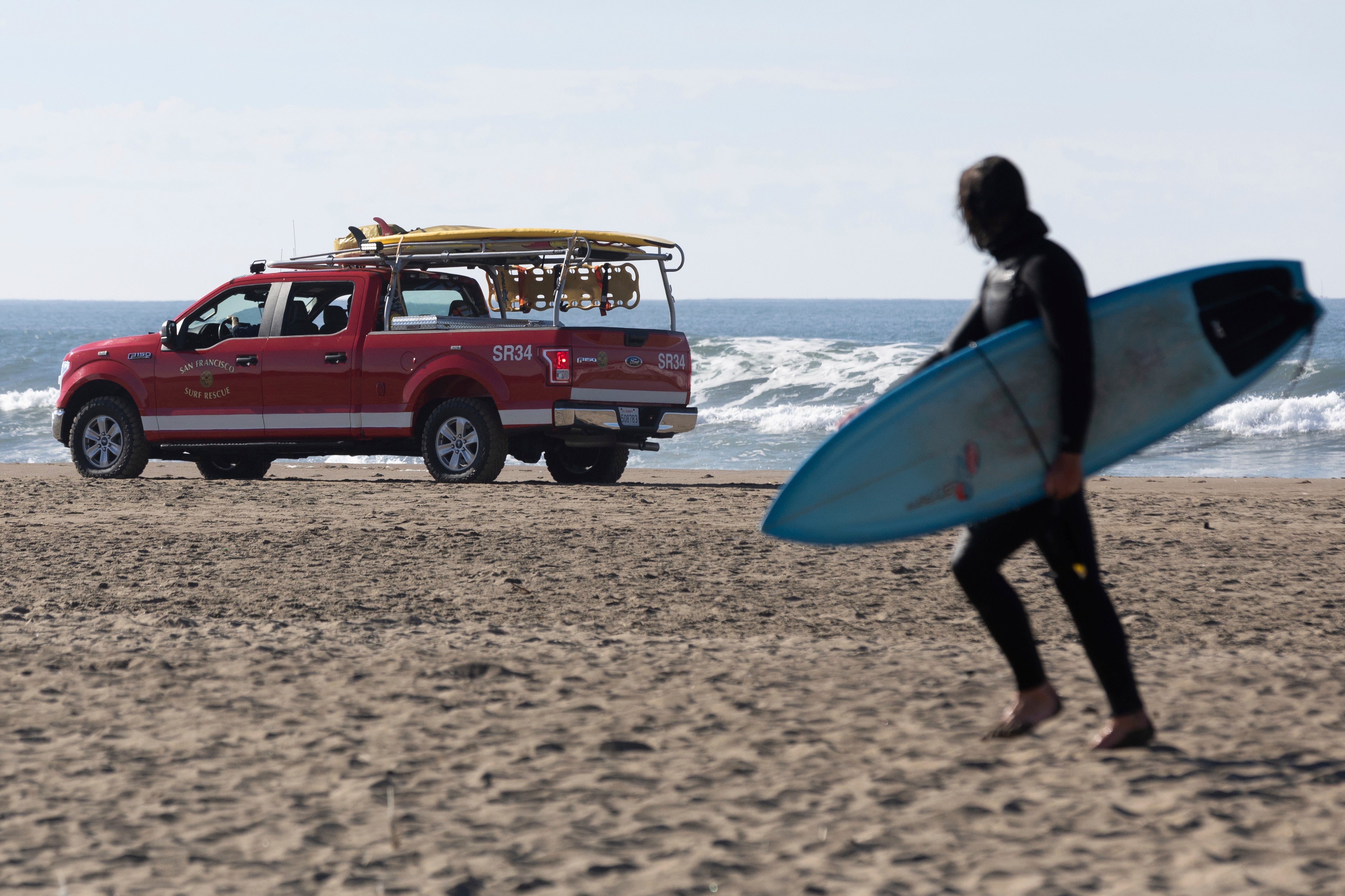 A San Francisco Surf Rescue team evacuates surfers from Ocean Beach in case of a possible tsunami on Thursday, Dec. 5, 2024