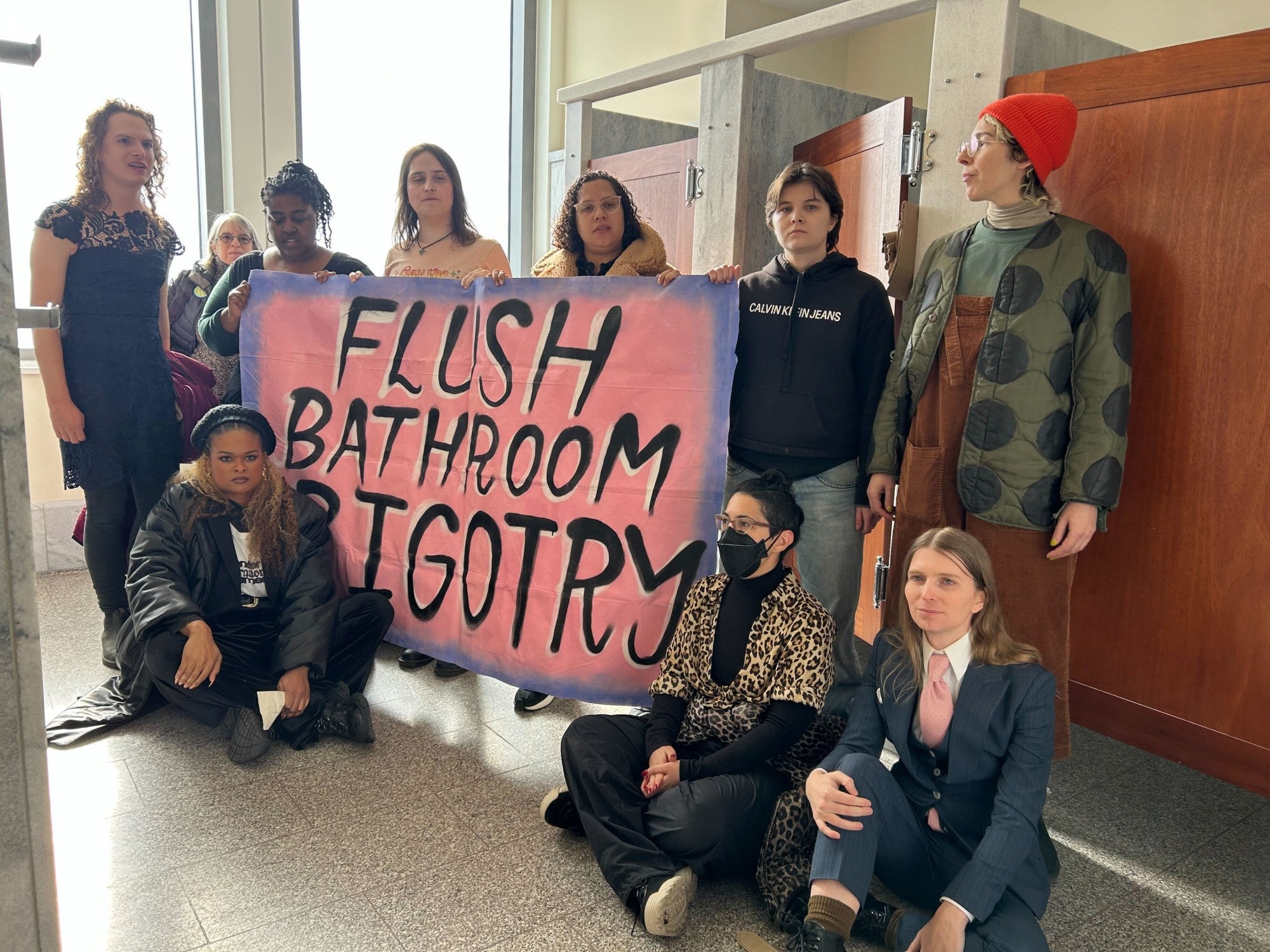 Chelsea Manning, bottom-right, sits with other protesters in a congressional bathroom on Thursday December 5, 2024