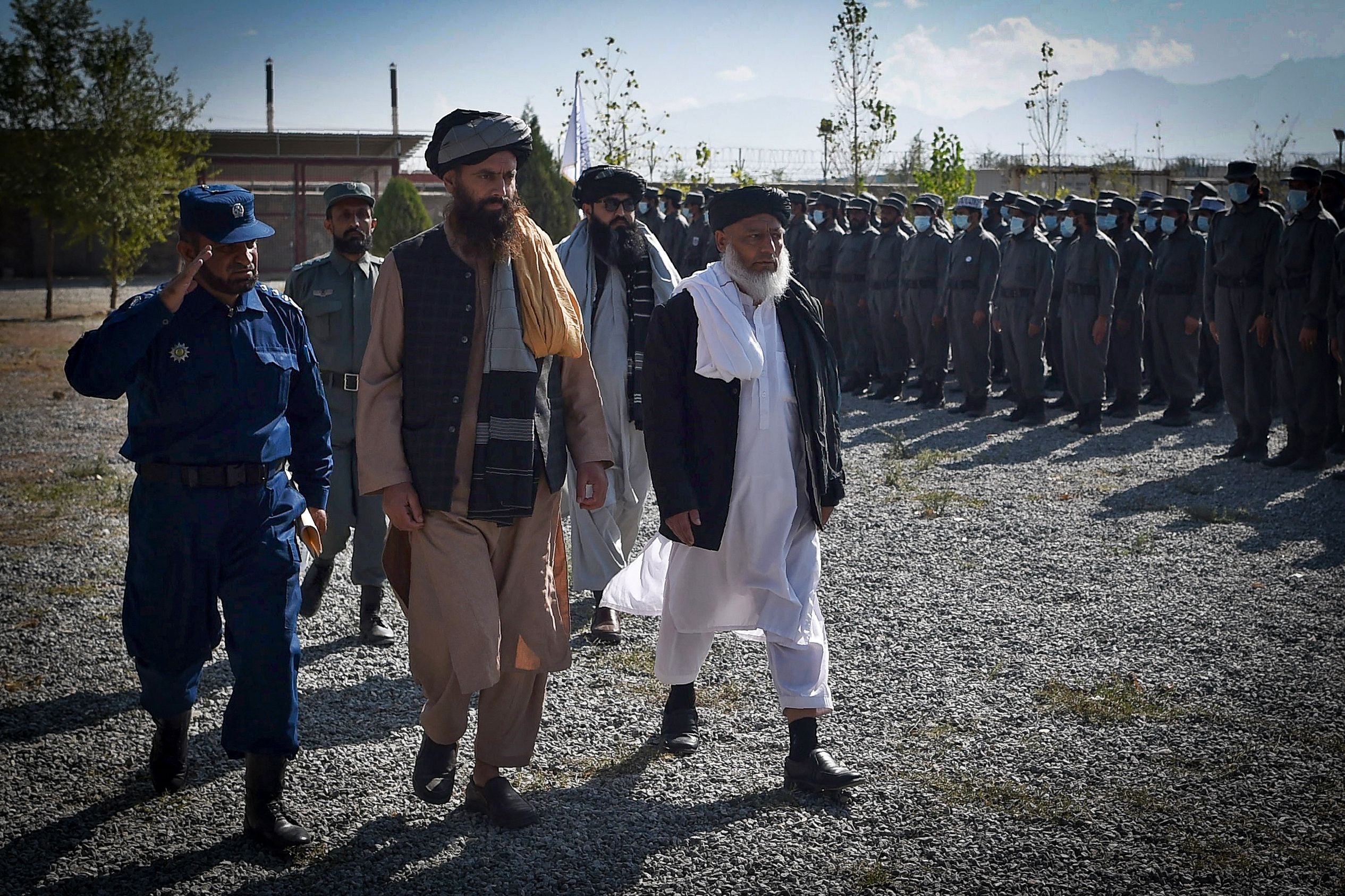 Mowlavi Abdullah, the acting director for prisons management, inspects as newly recruited Taliban prison guards stand in formation during their graduation ceremony at Pul-e-Charkhi prison