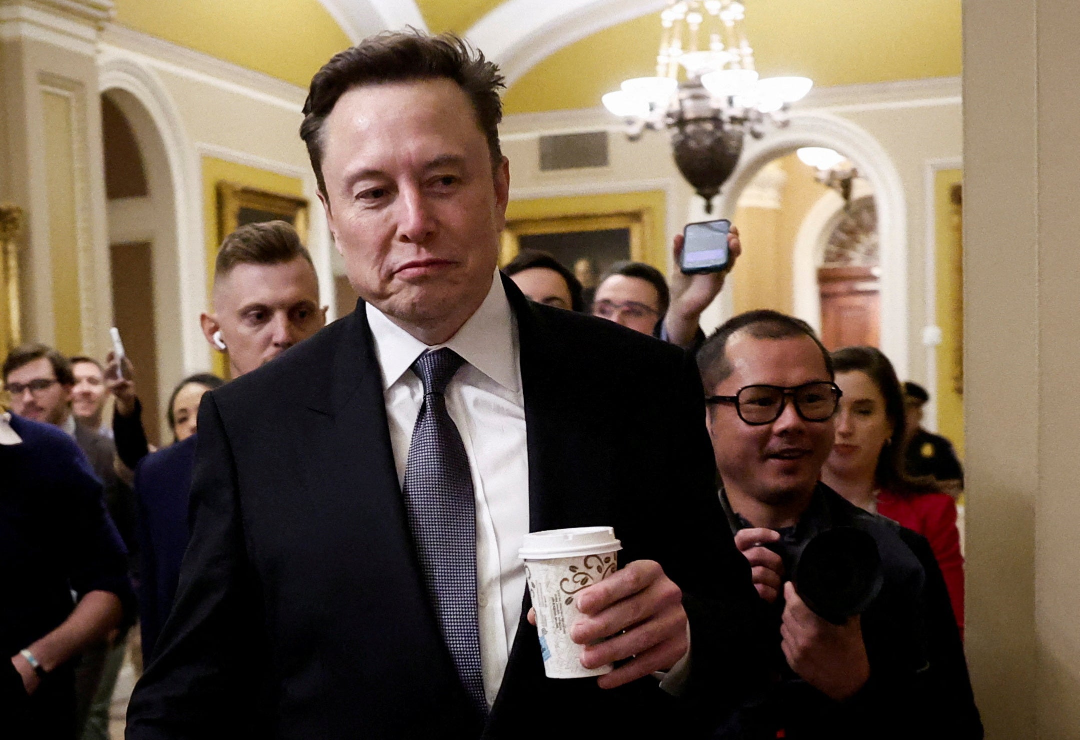 Elon Musk walks on Capitol Hill on the day of a meeting with Senate Republican Leader-elect John Thune (R-SD), in Washington, U.S. December 5, 2024.