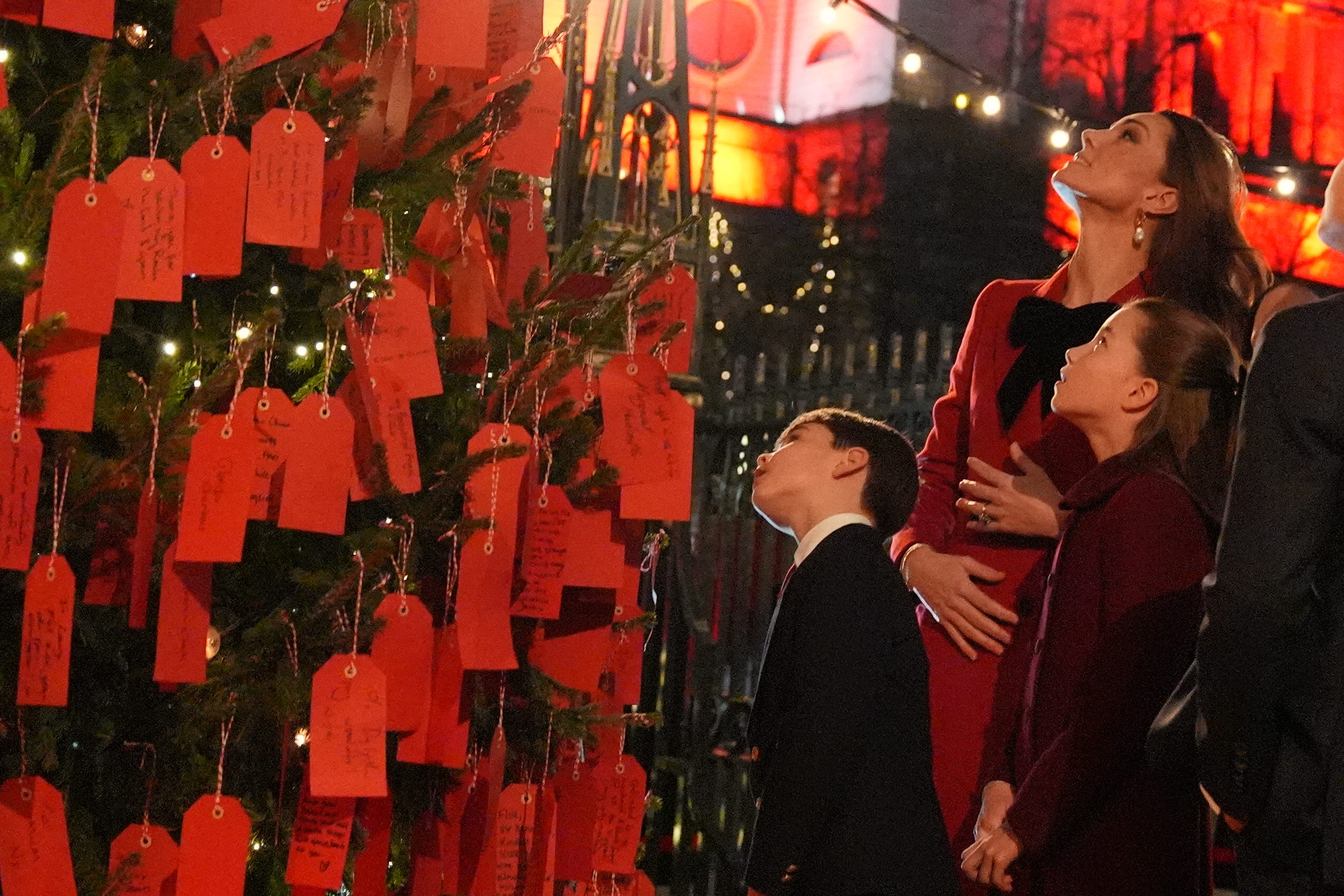 The Princess of Wales, Princess Charlotte and Prince Louis look at messages on the kindness tree (Jordan Pettitt/PA)