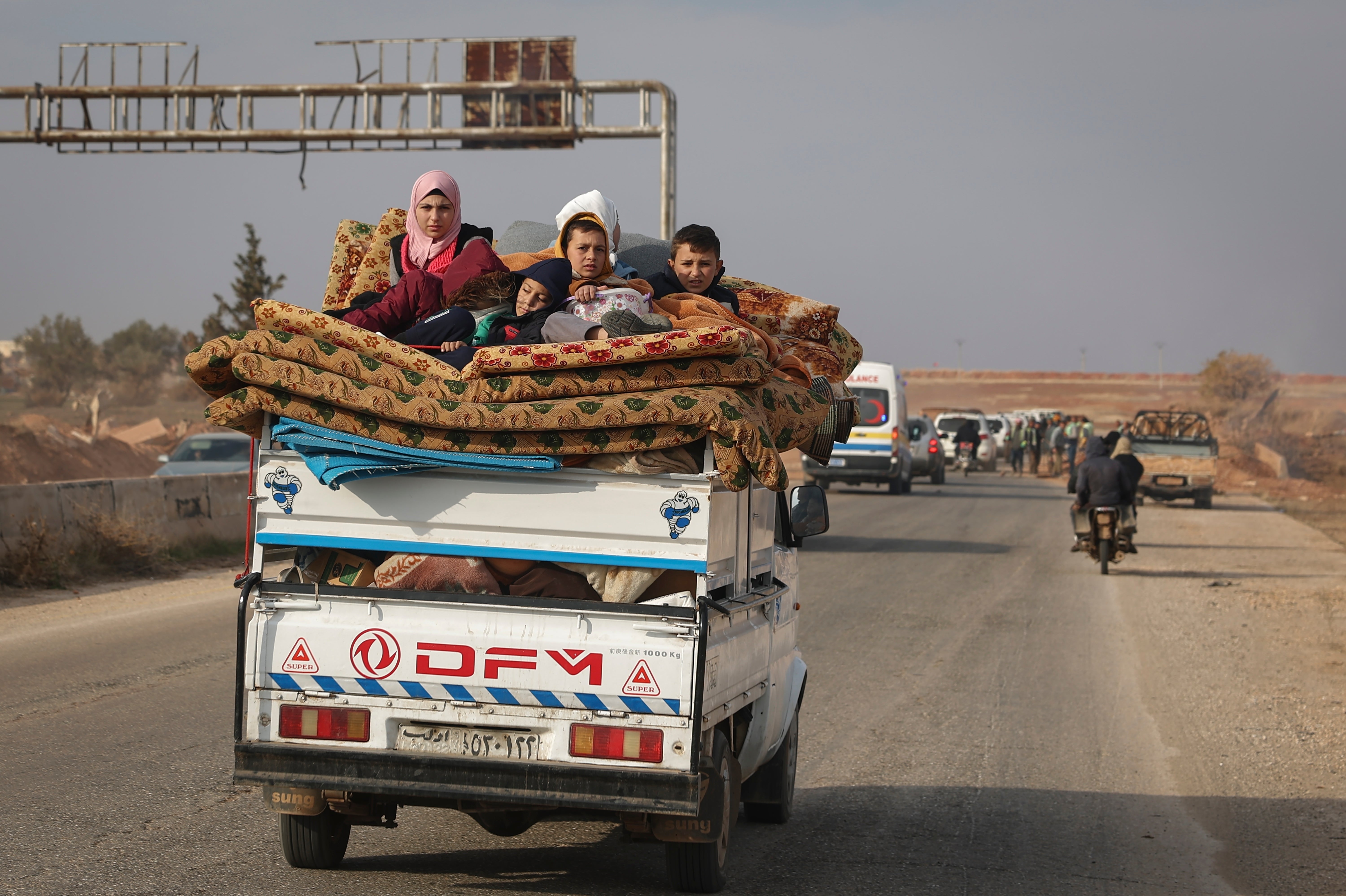 Residents leave the city carrying their belongings in the aftermath of the opposition's takeover of Hama, Syria, on December 6