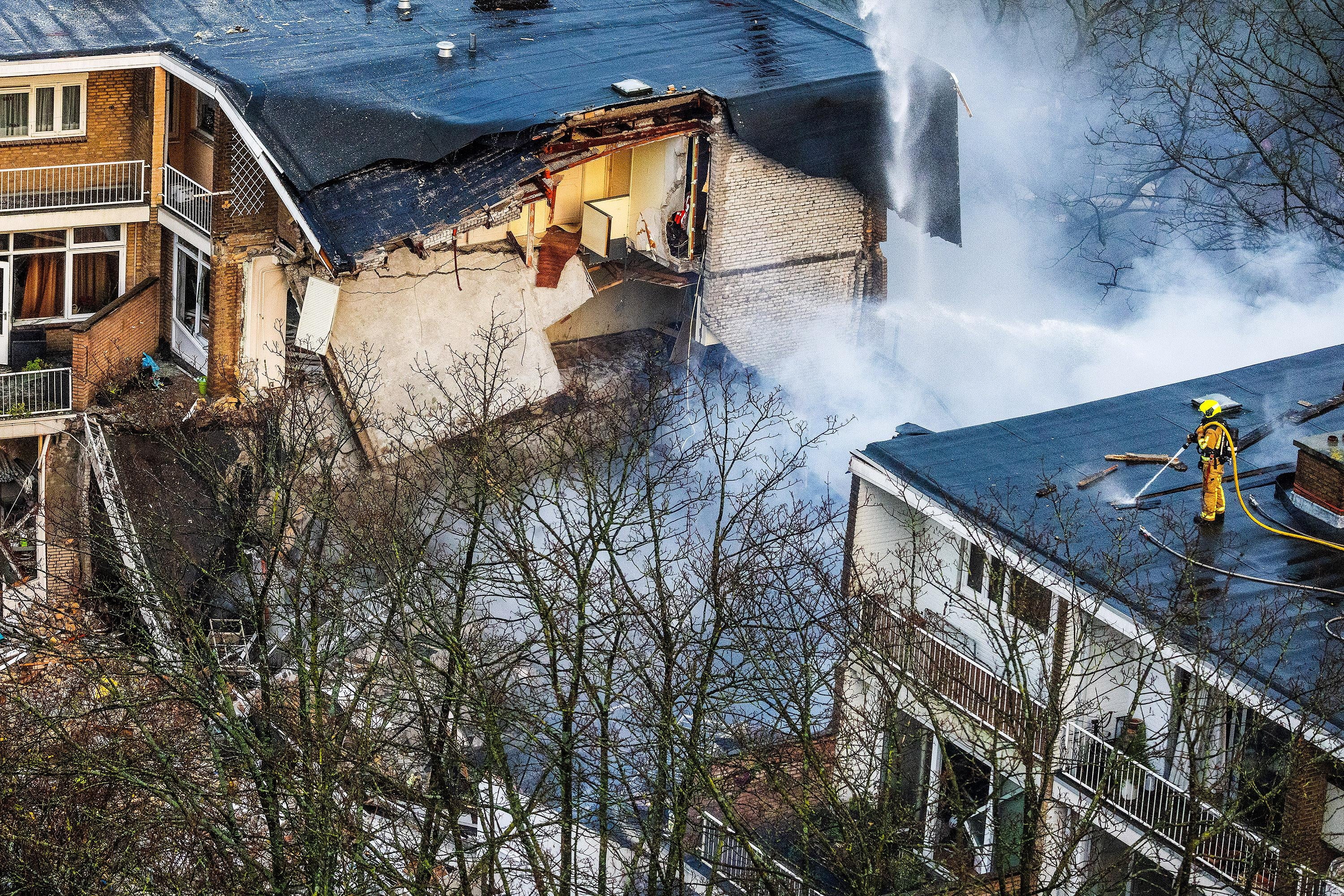 Firefighters douse the blaze that followed the explosions