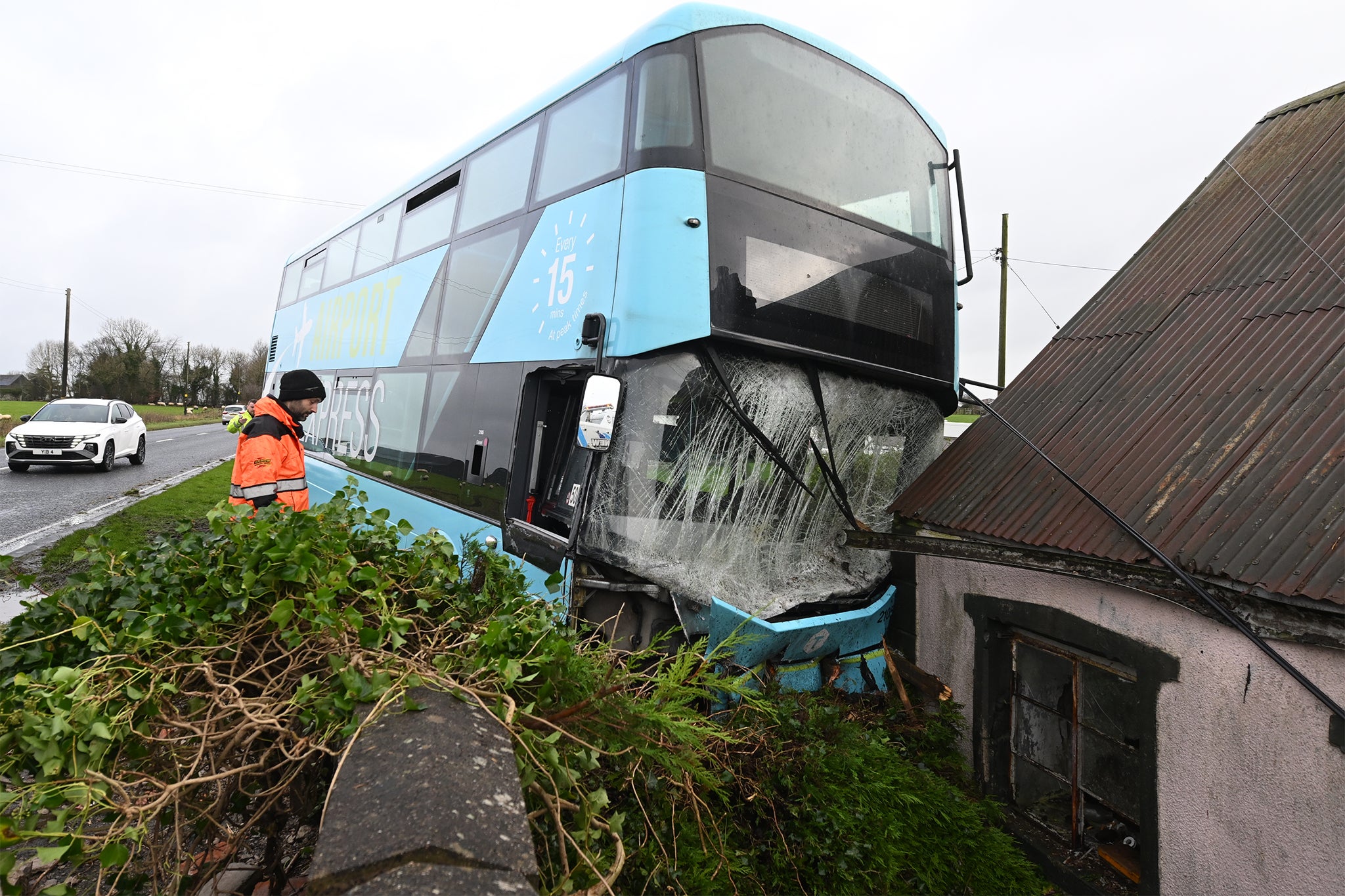 An airport transfer bus left the road and crashed into a house in Northern Ireland