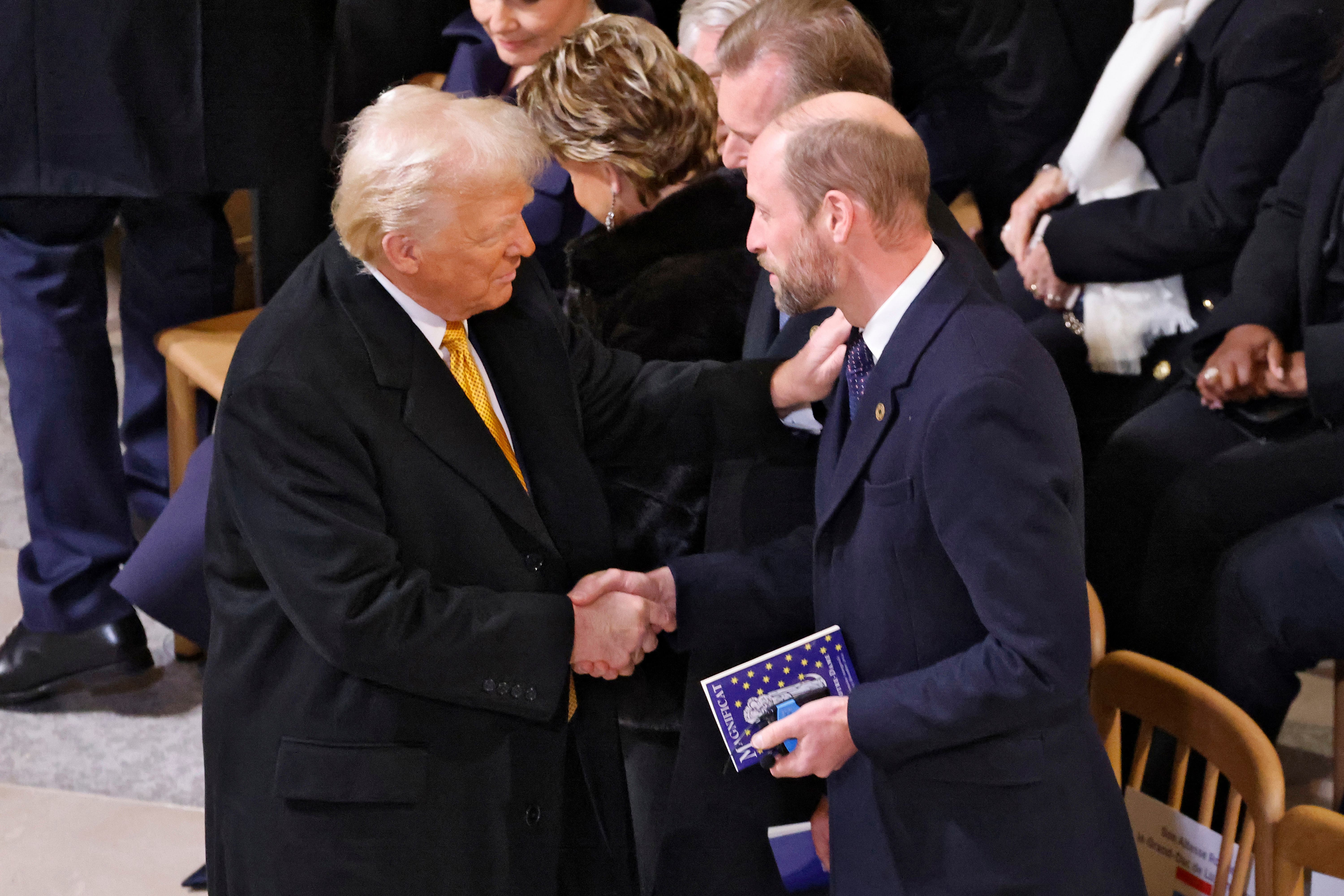 President-elect Donald Trump talks to William (Ludovic Marin, Pool via AP)