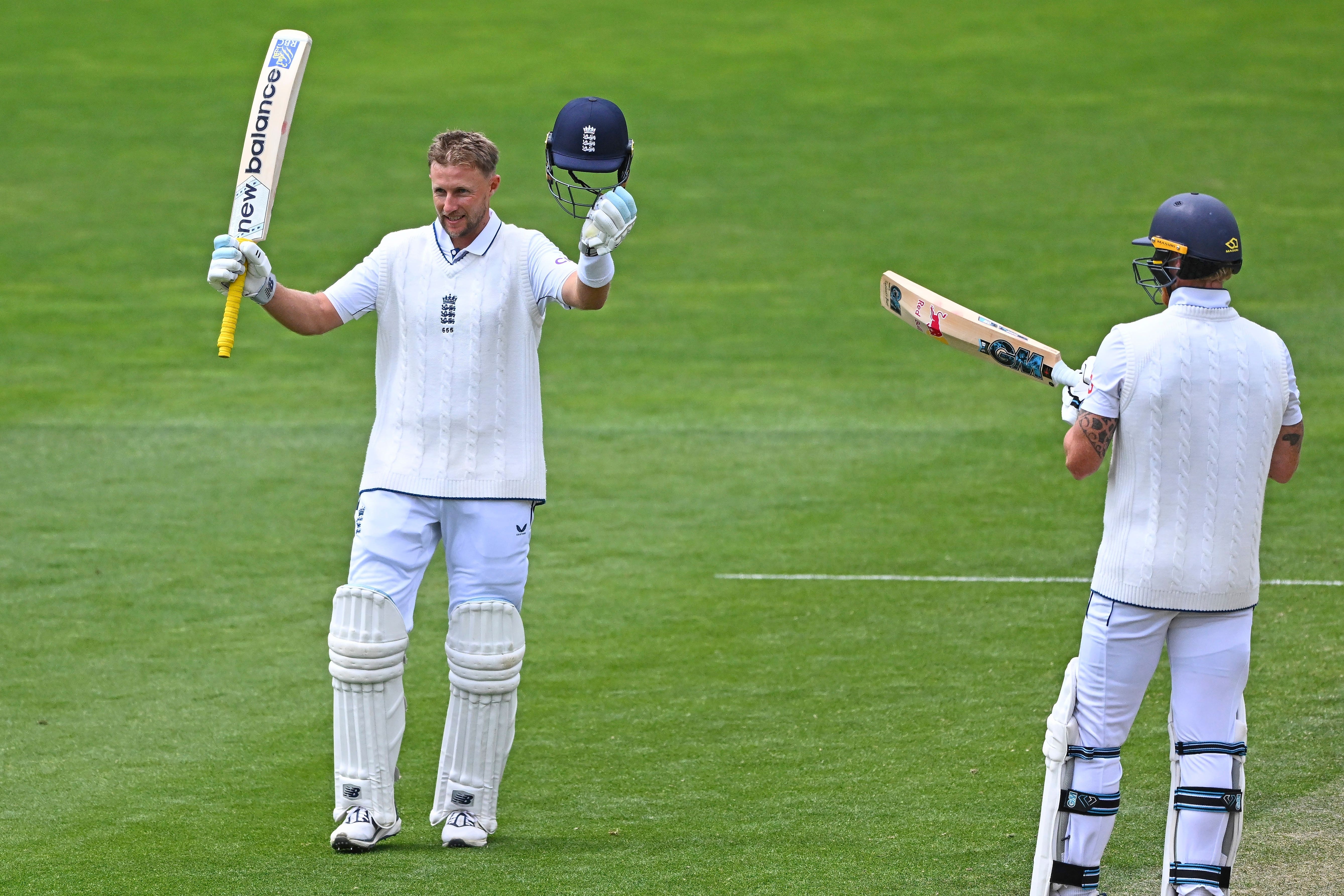 England’s Joe Root celebrates after scoring a century as teammate Ben Stokes, right, watches (Kerry Marshall/Photosport via AP)