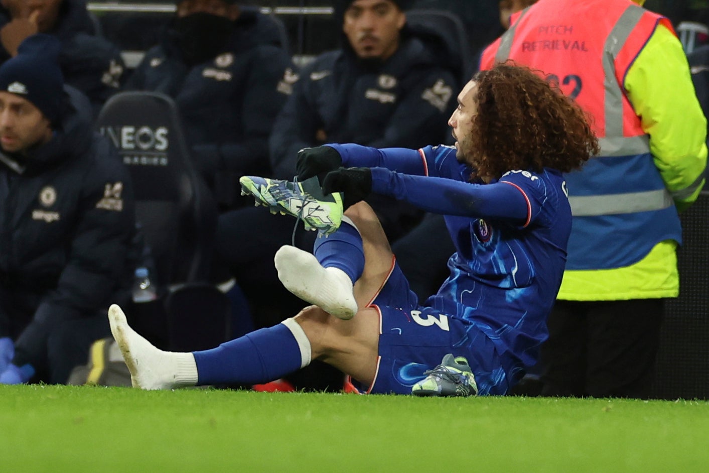 Marc Cucurella switches boots on the side of the pitch