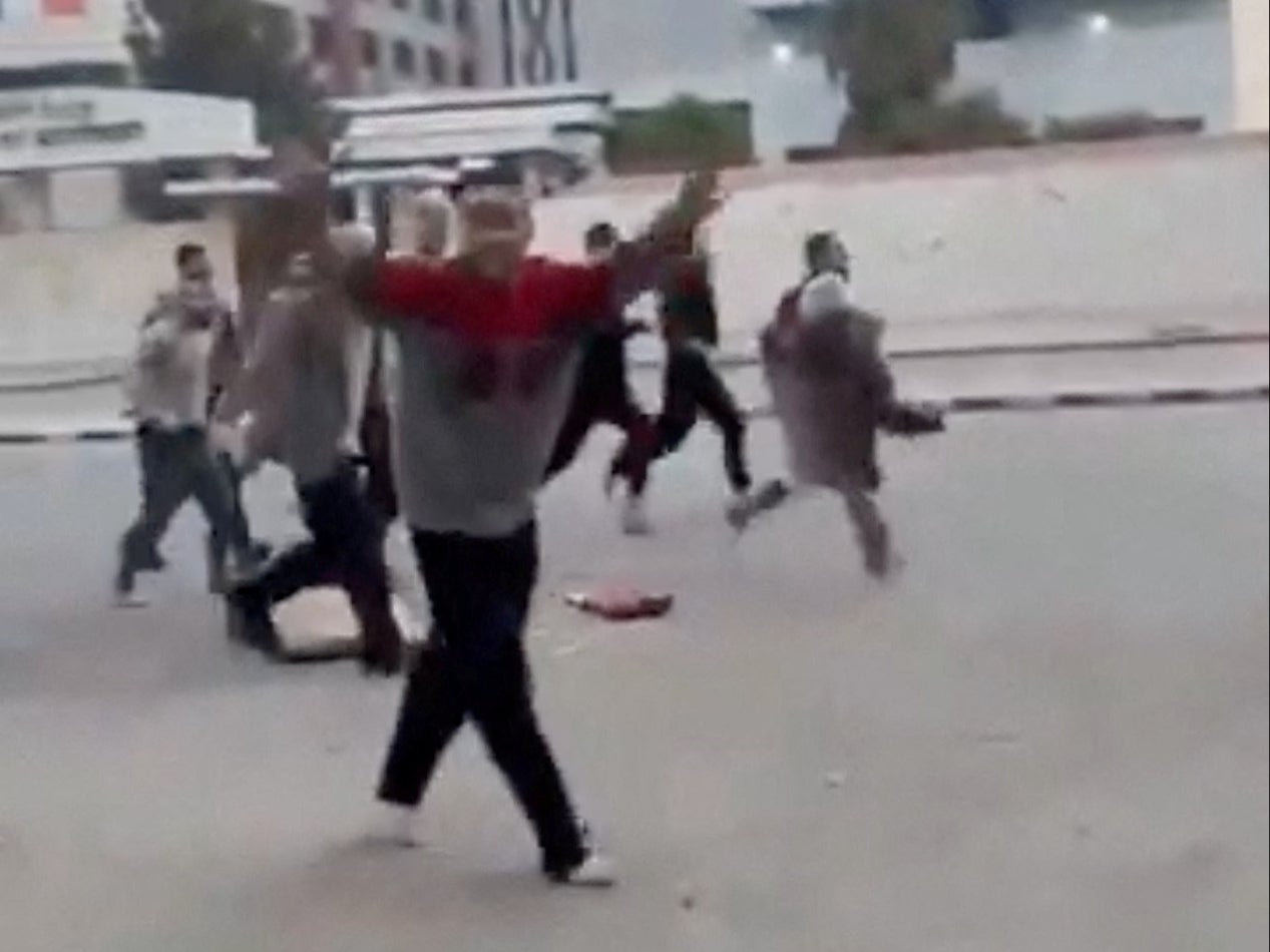 A person gestures as individuals, reportedly freed prisoners, run in the streets of Damascus, Syria