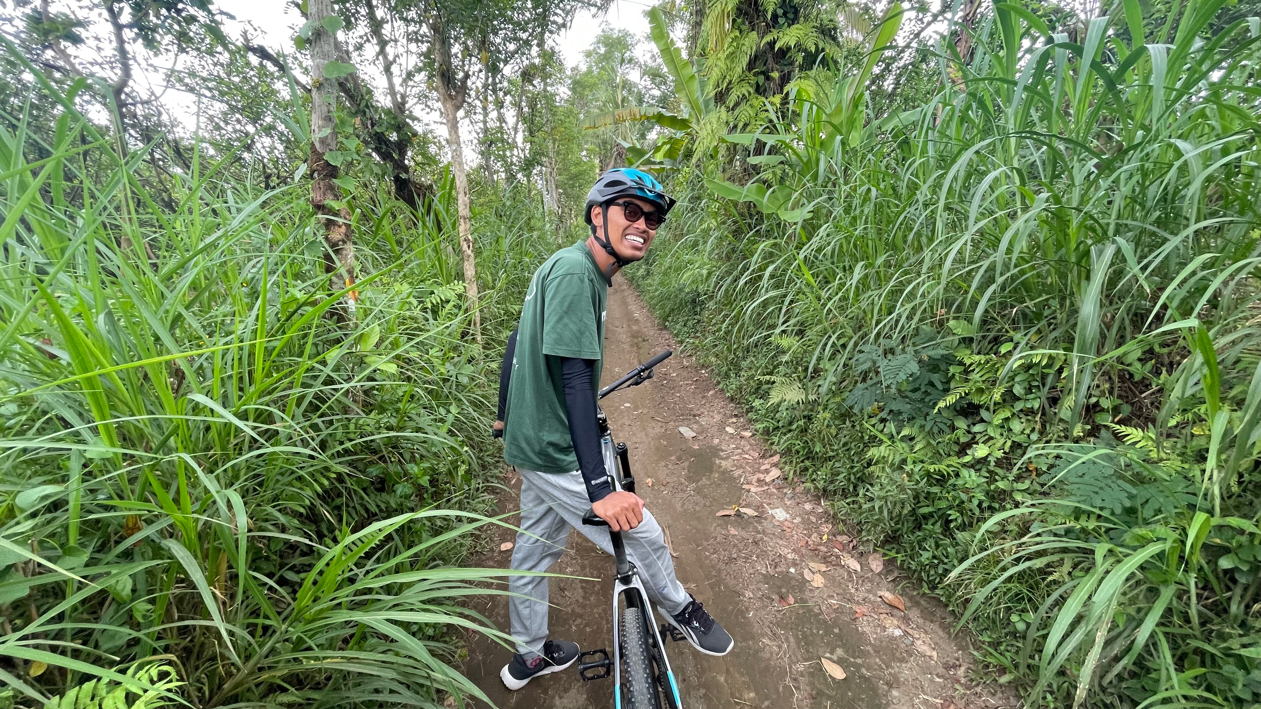 Dewa gives the writer a gentle downhill cycling tour of village life