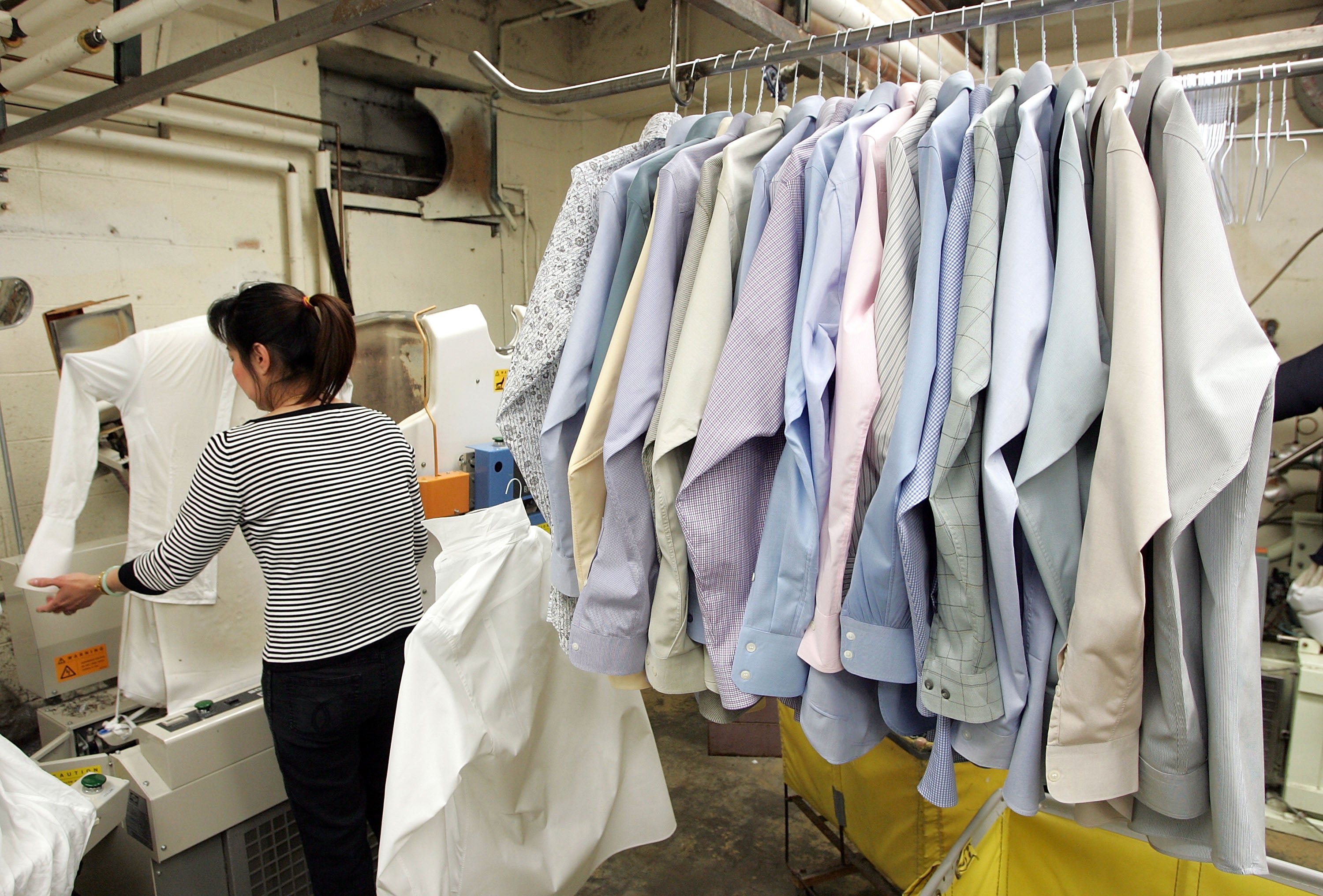 A worker at Sohn’s French Cleaners, which uses eco-friendly chemicals to dry clean clothes, presses shirts in January 2007 in San Francisco, California. The Environmental Protection Agency announced the ban of chemicals that are commonly used at dry cleaning businesses and can cause cancer