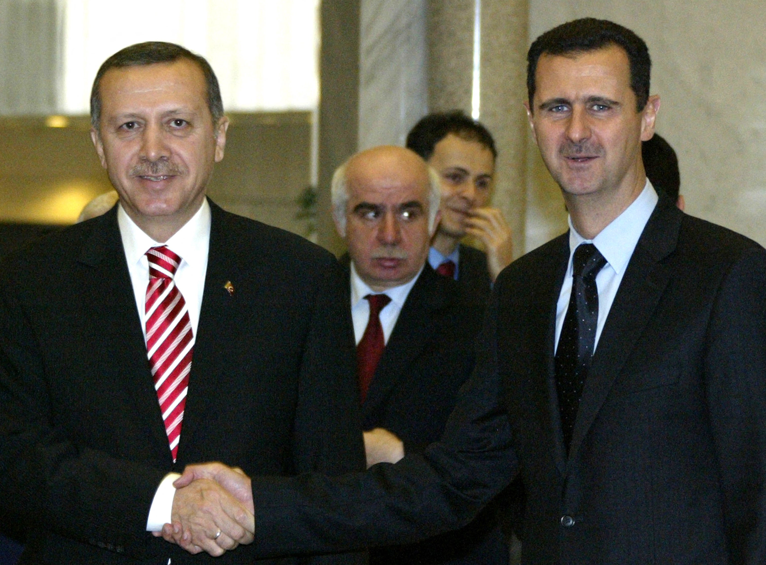 Syrian President Bashar al-Assad (R) shakes hands with Turkish Prime Minister Recep Tayyip Erdogan in 2008