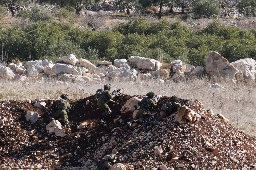 Israeli soldiers take position near the so-called Alpha Line that separates the Israeli-annexed Golan Heights from Syria, in the town of Majdal Shams